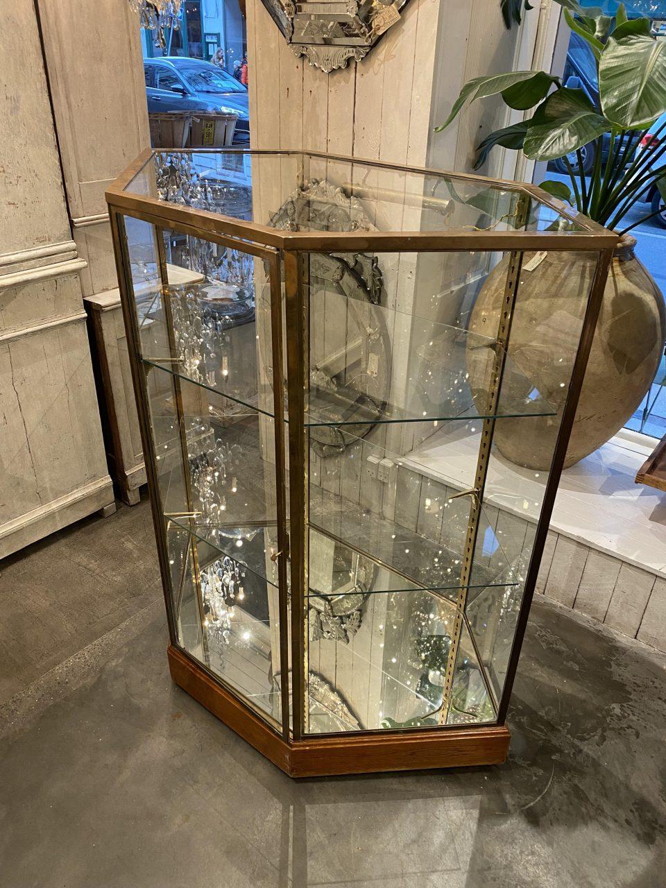 Tall handsome French 6-sided shop showcase / display cabinet, from the beginning of the last century. Beautiful detailing. Originally part of a boutique inventory, from an exclusive department store in Lyon, where it was used to display fine leather