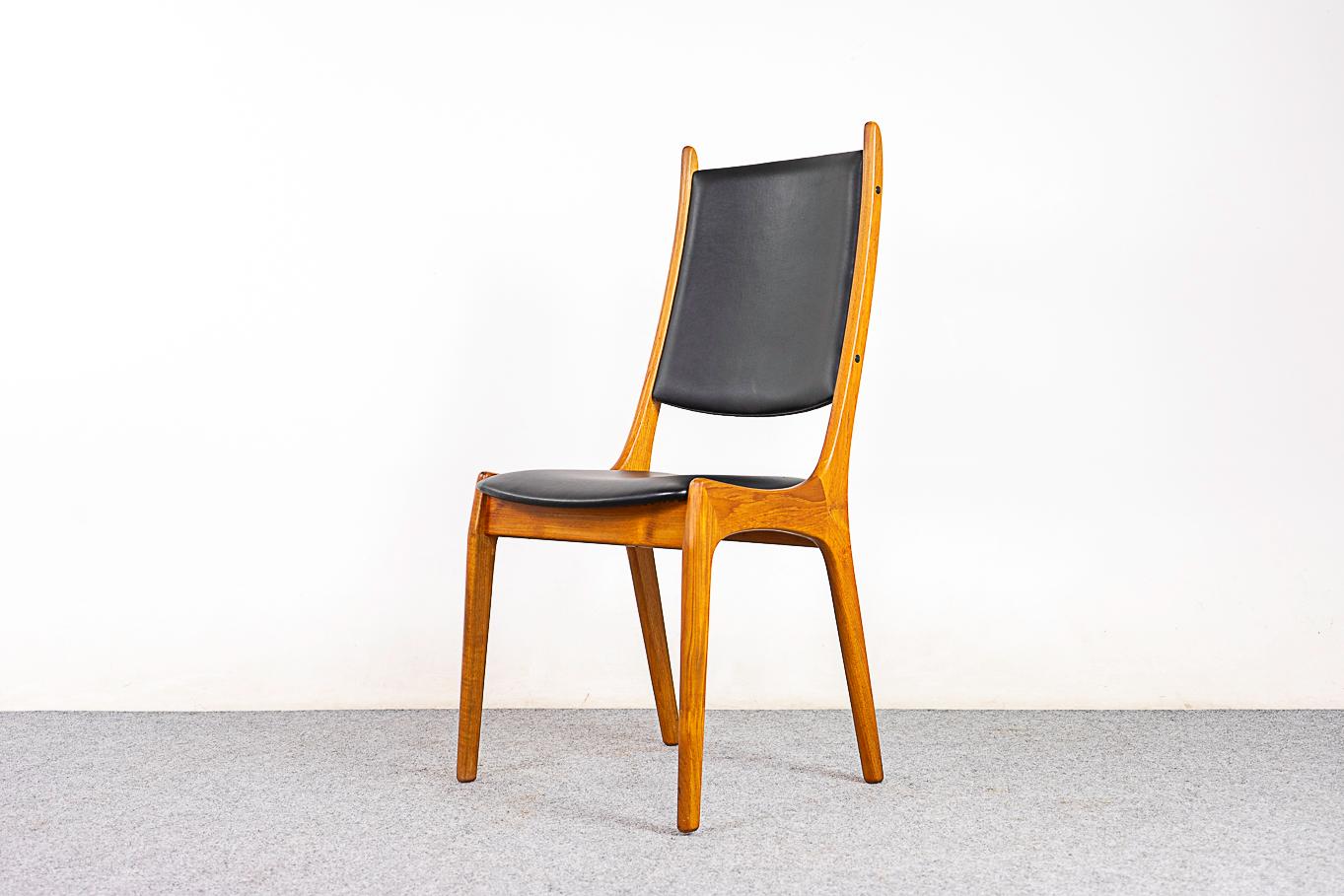 Teak mid-century dining chairs, circa 1960's. Robust solid wood construction. Curving backrests with great support and comfortable generous seat. Original black vinyl upholstery in great condition. 