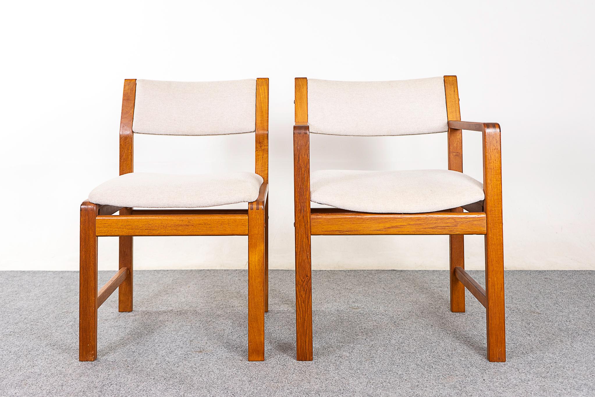 Teak dining chairs, circa 1980's. Simple, sturdy design with 2 captain's chairs.  

Unrestored item with option to purchase in restored condition. Restoration includes: repairs, sanding, staining and an oil finish. Reupholstery not included.

Please