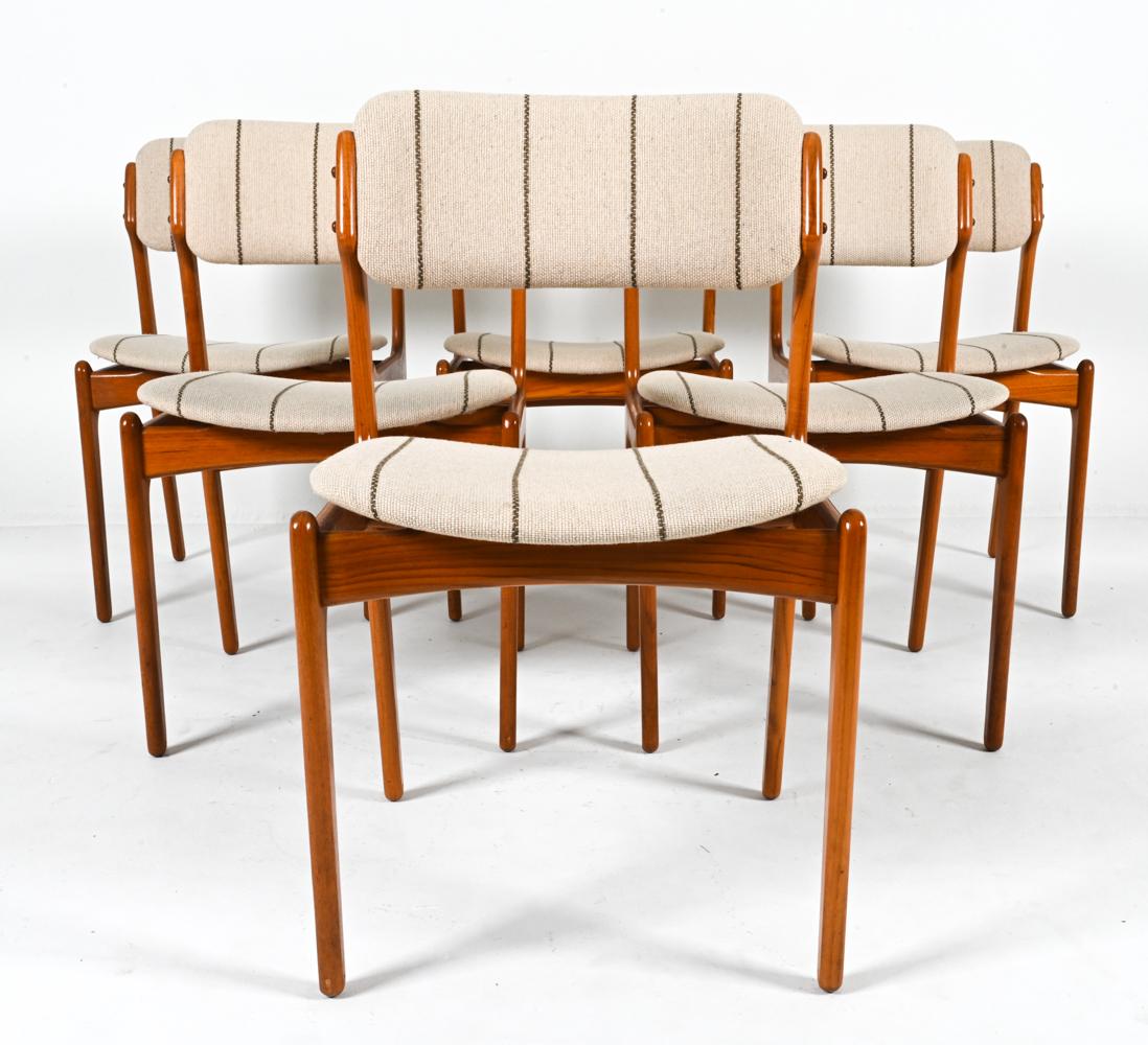 Imbue your dining space with a touch of Danish Modern elegance with this captivating set of (6) mid-century side chairs designed by Erik Buch. Known as 'Model #49', these chairs showcase the hallmarks of Scandinavian design – clean lines, expert