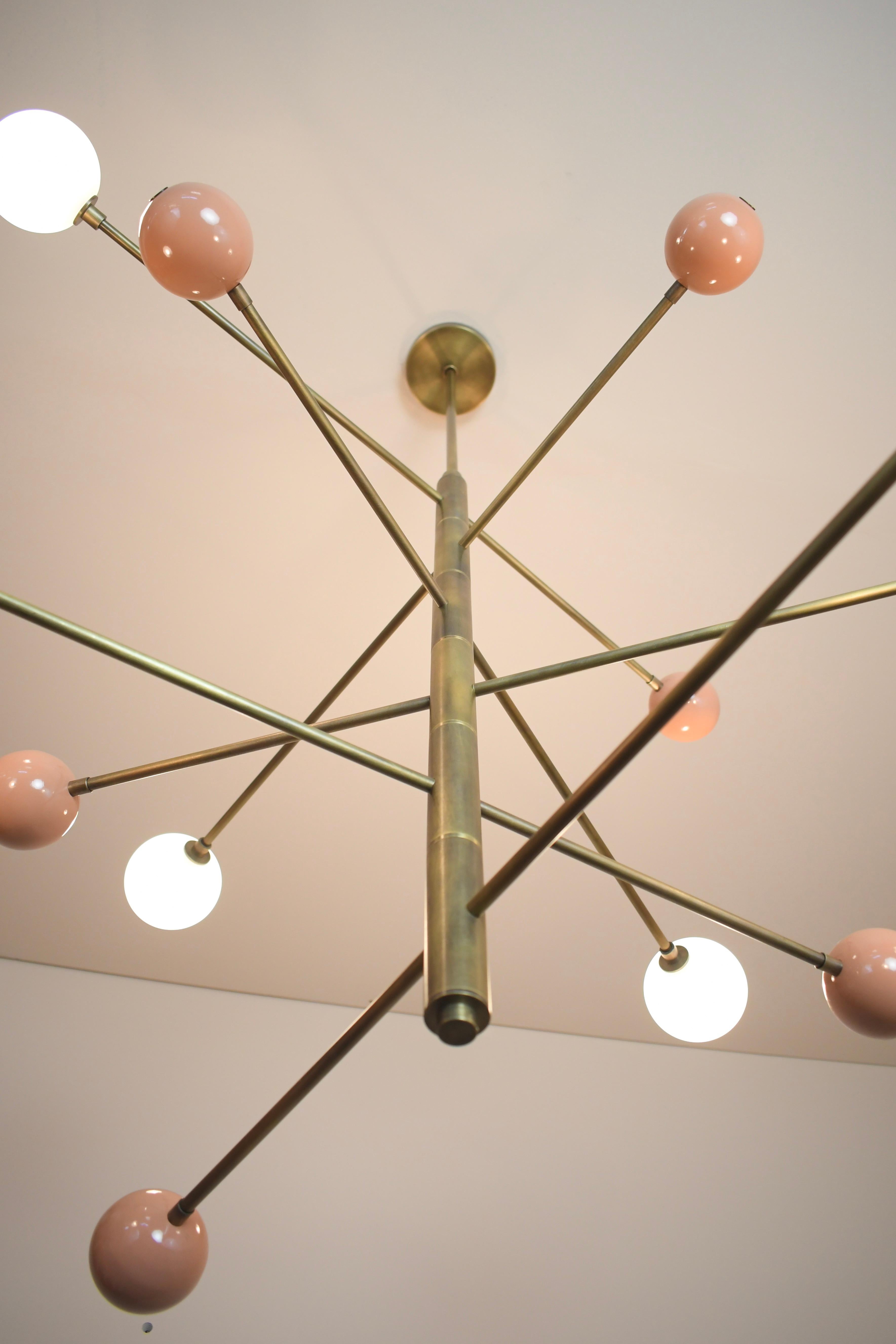 Handcrafted in NYC by Blueprint Lighting, our 'Orbital' Chandelier is a commanding statement piece with design elements of both Italian and French modernism as well as Hollywood Glam and is a stunning study in mixed materials. 
All arms of this