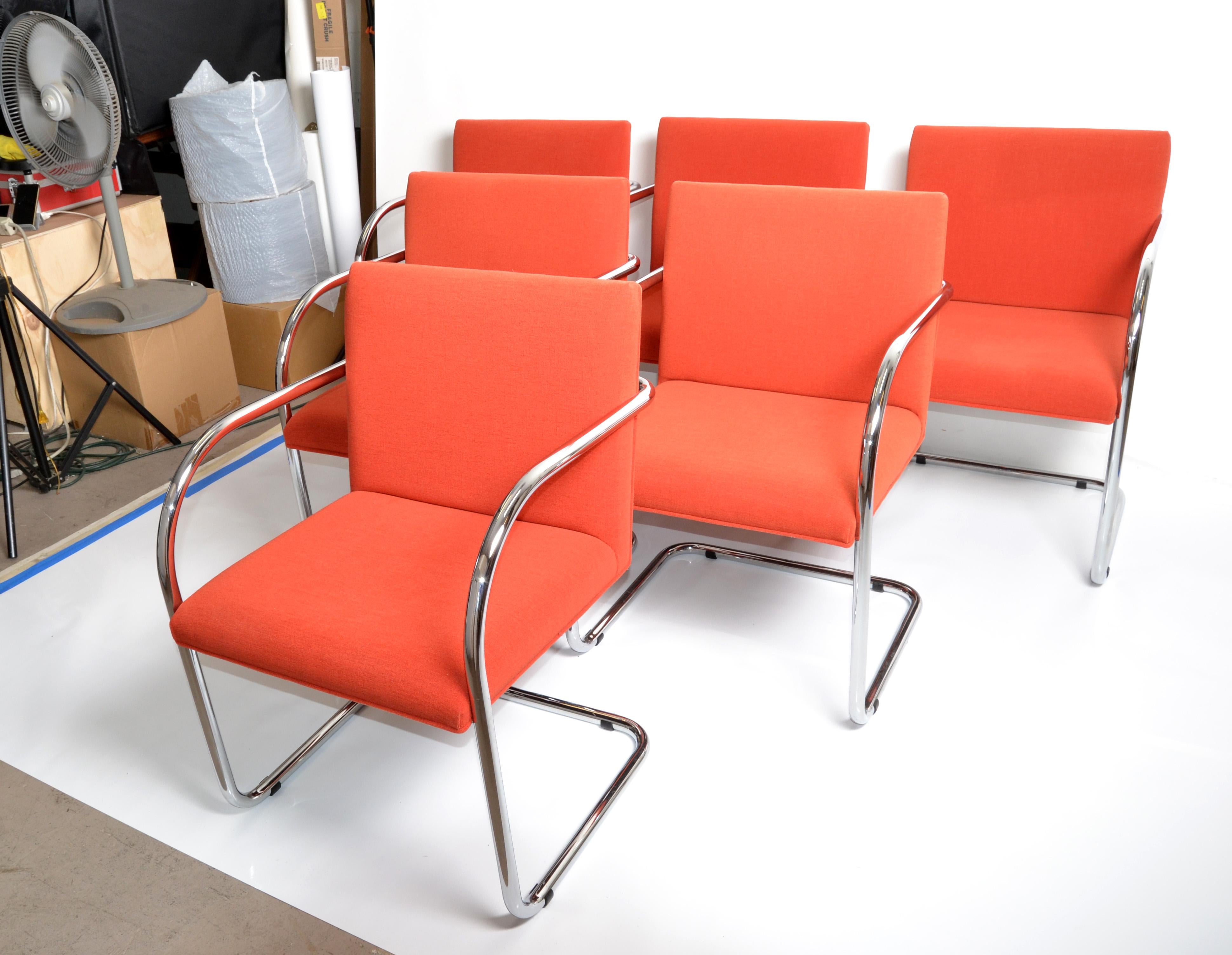 Set of Ludwig Mies van der Rohe attributed Brno armchairs or dining room chairs in original coral red fabric upholstery. 
Solid chrome tubular frames with cantilever swing, very comfortable.
Marked with original paper tag under the seat, Gordon