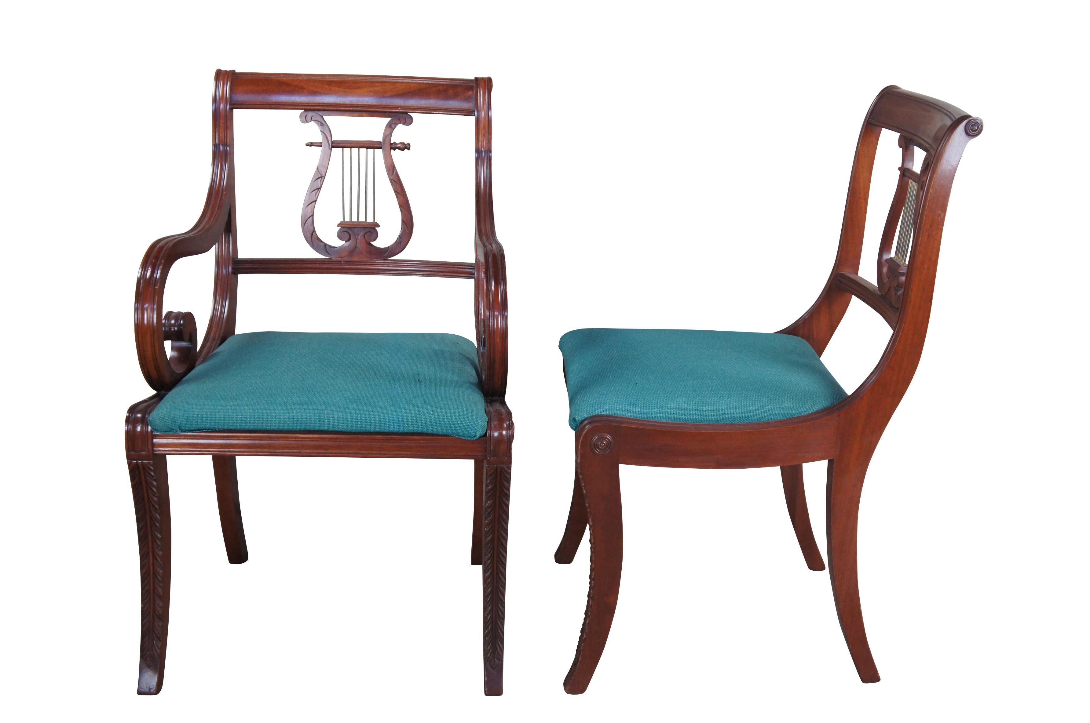 Set of 6 Union National Regency / Duncan Phyfe style dining chairs, circa 1940s.  Features a mahogany frame with harp or lyre back over a padded seat and acanthus carved saber legs.  Includes 2 arms and 4 side chairs.  Seats are covered in a green