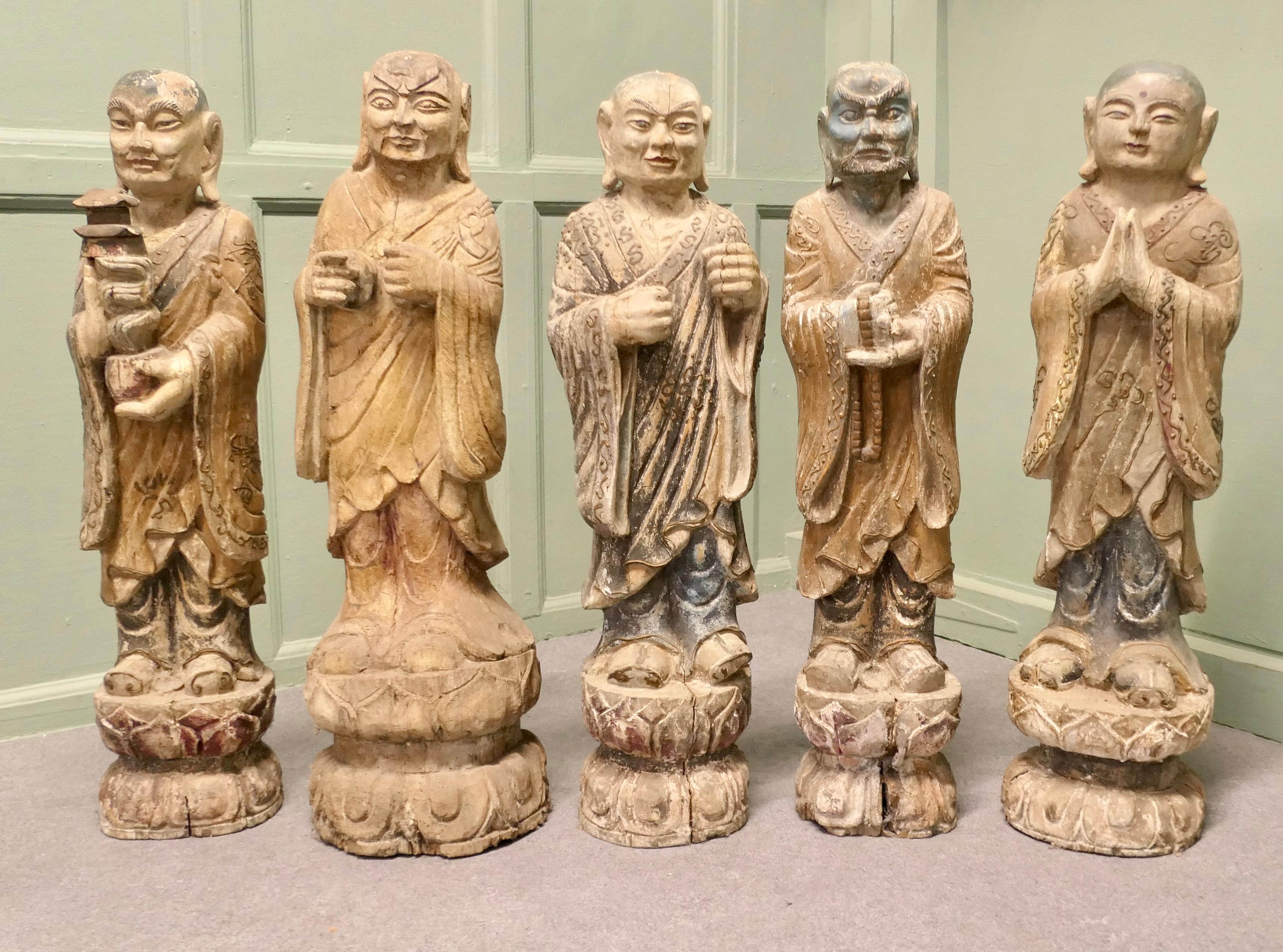 6 Very Old Carved Figures of Buddhist Immortals
 
These lovely statues date from the 18th/19th Century, each one is carved from a single piece of wood, the garments are carved in fine detail, the Deities have their hands held in different