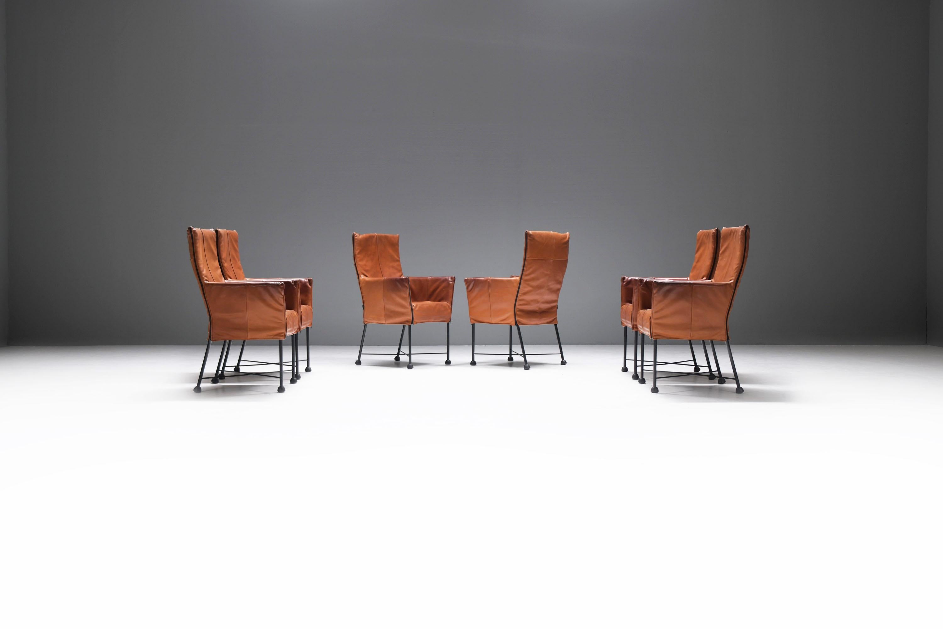Exceptional set of 6 Chaplin dining armchairs.  Stunning patinated, thick leather.  Hard to find in this color.
Designed by Gerard van den Berg for Montis, the Netherlands (1983)

The leather cover hangs nonchalantly on the chair like a padded