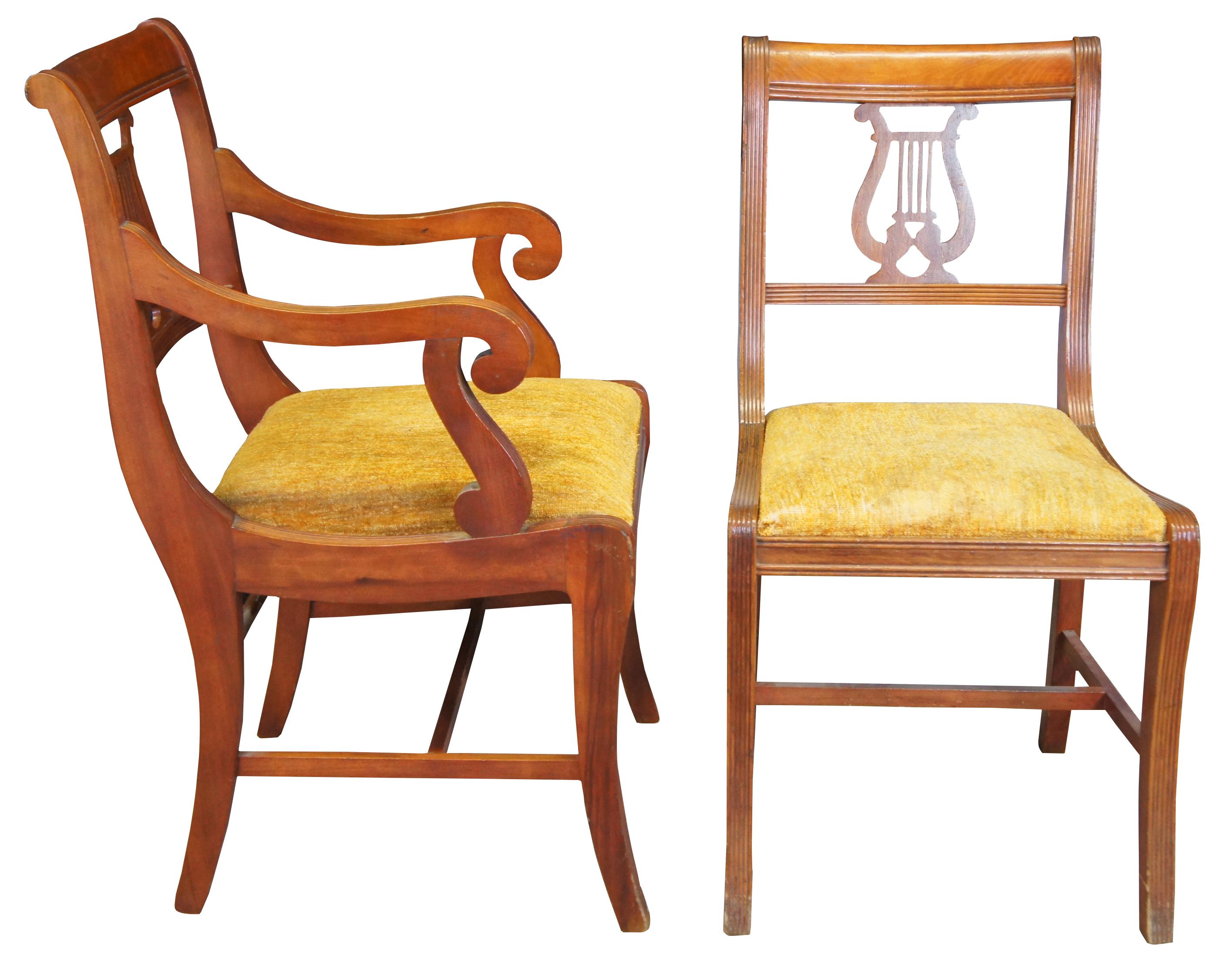 Six Duncan Phyfe dining chairs, circa mid 20th century. Made of mahogany featuring serpentine form with a lyre/harp back and fluted accents. 705-185, H-6746.

Measures: 21