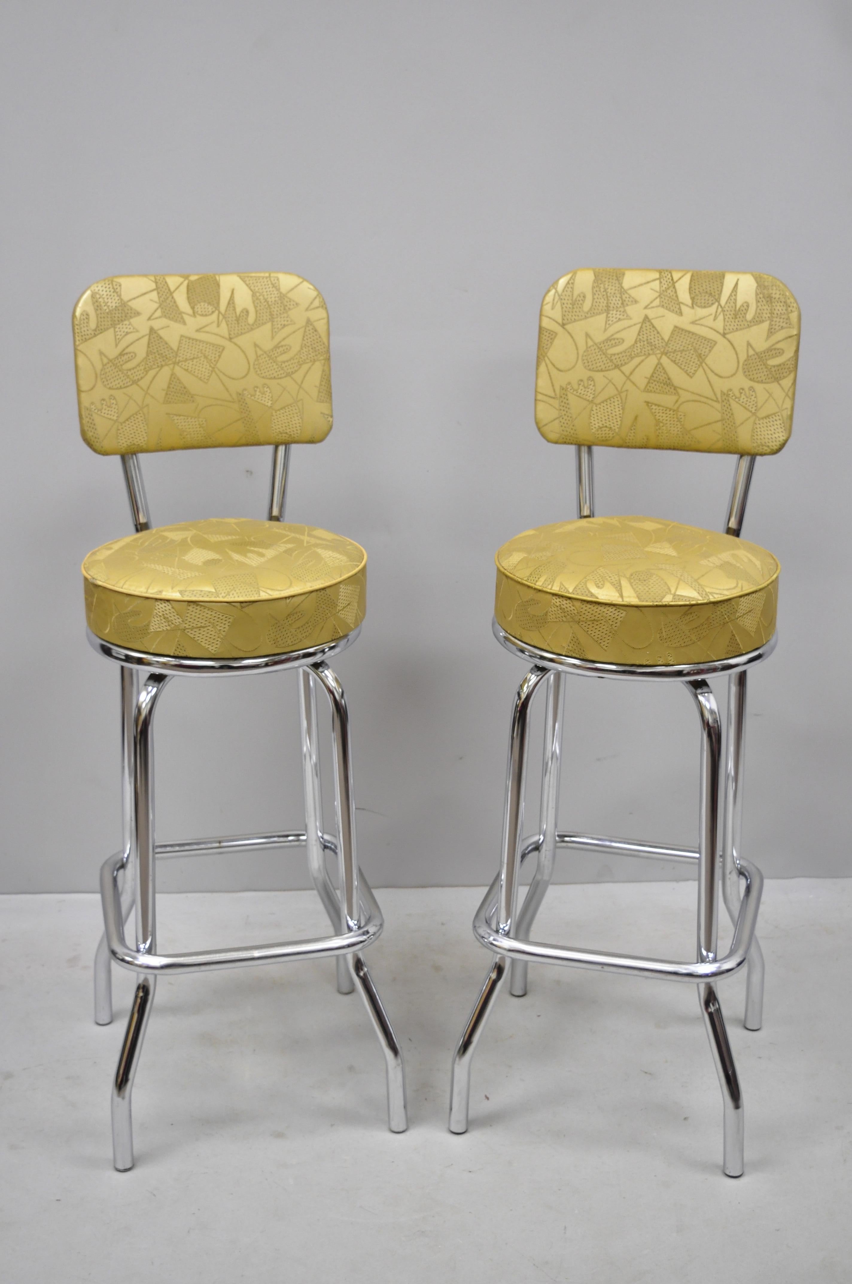 6 vintage Mid-Century Modern metal swivel bar stools by Krometal Mfg with Gold Vinyl. Listing features (6) swivel bar stools, original gold vinyl upholstery, upholstered backs, metal frames, original label, quality American craftsmanship, circa