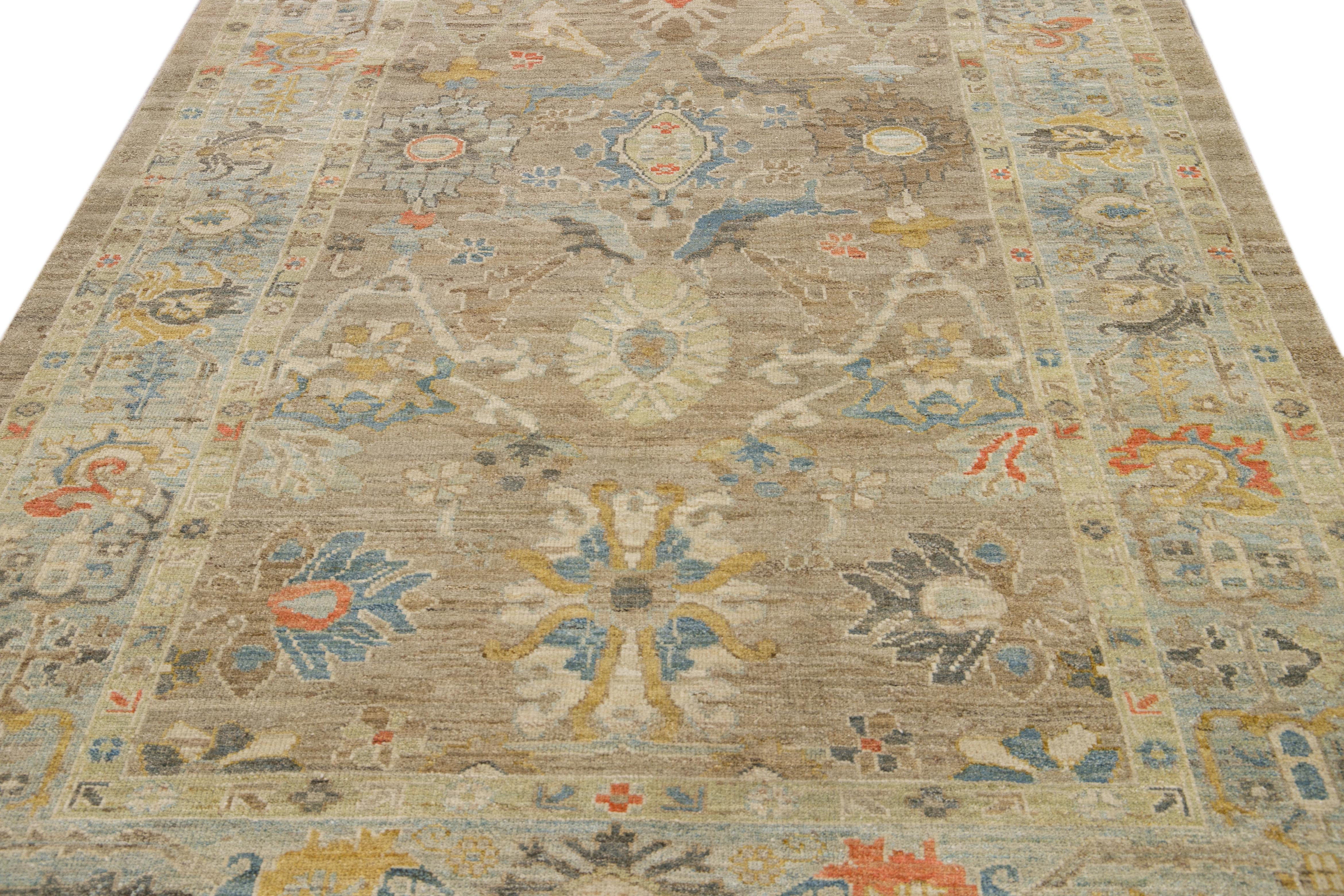 This beautifully handwoven oriental rug, featuring a classic central medallion and intricate floral and geometric patterns. The muted tones of beige, blue, red, and soft yellow create a warm, inviting palette that complements both traditional and