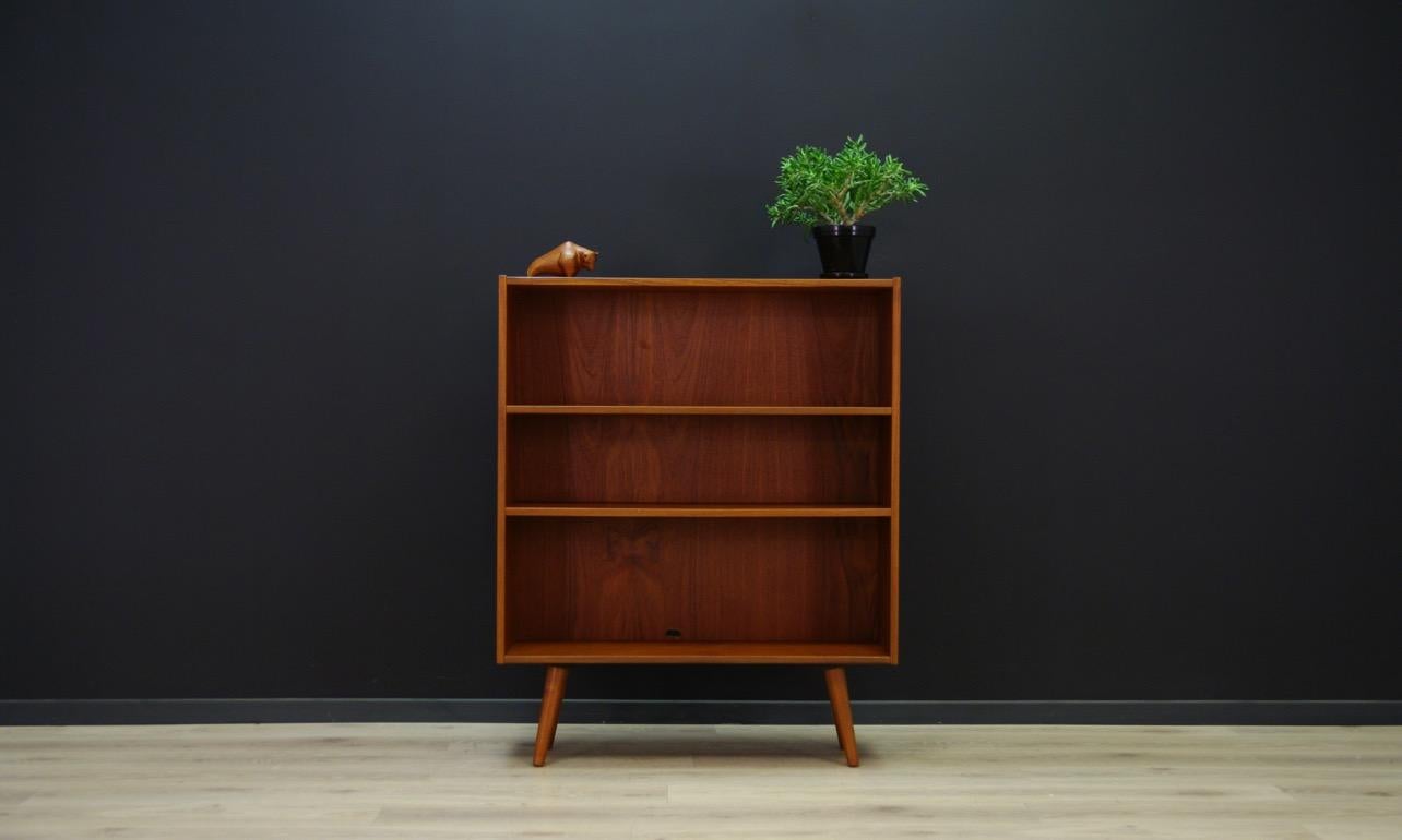Elegant bookcase from the 1960s-1970s, Minimalist form, Scandinavian design. Furniture finished with teak veneer. The shelf has shelves. Preserved in good condition (small bruises and scratches), directly for use.

Dimensions: Height 140 cm, width