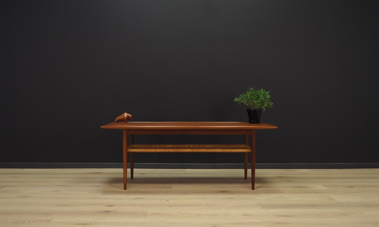 Classic coffee table from the 1960s-1970s, Scandinavian design - a Minimalist form. tabletop covered with teak veneer, teak construction. An additional advantage is the shelf under the top, made of braids. Preserved in good condition (minor