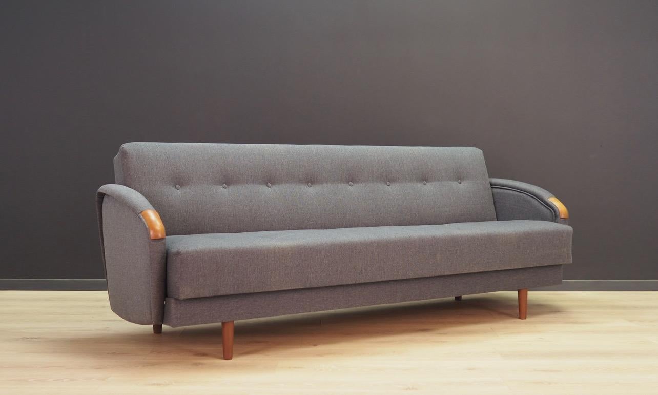 Scandinavian sofa from the 1960s-1970s, Danish design, Minimalist form with the possibility of sleeping arrangements, underneath chest for bedding. Phenomenal armrests, upholstery after replacement (color - gray). Preserved in good condition -