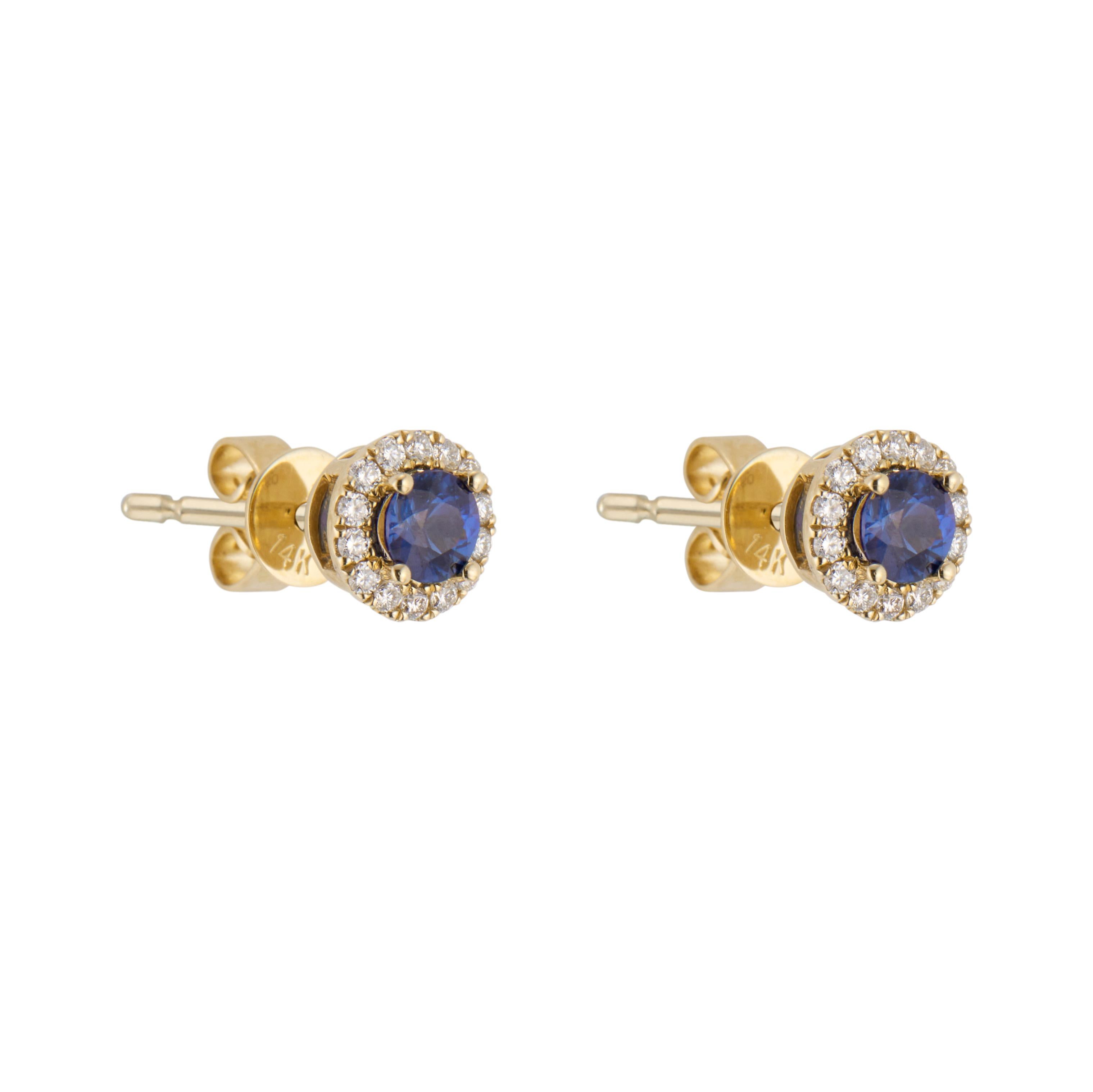 Sapphire and diamond stud earrings. 2 round blue sapphires, each with round cut diamond halos set in 14k yellow gold 4 prong settings. 

2 round blue sapphire, approx. .60cts
28 round brilliant cut diamonds, approx. .11cts
14k yellow gold 
Stamped: