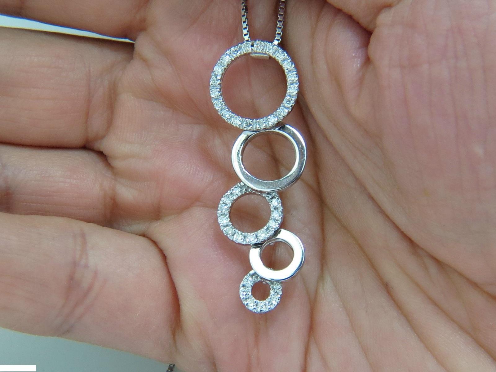 Loves & Sparkles.

The Circle dangles / Bubbles pendant.

.50ct. diamonds circles 

Rounds, hand selected from finest parcels.

 Full cut and Brilliant

F/G-color, Vs-2 clarity

Measurements: 

1.7 inch Long

.57 inch diameter at upper circle.

18