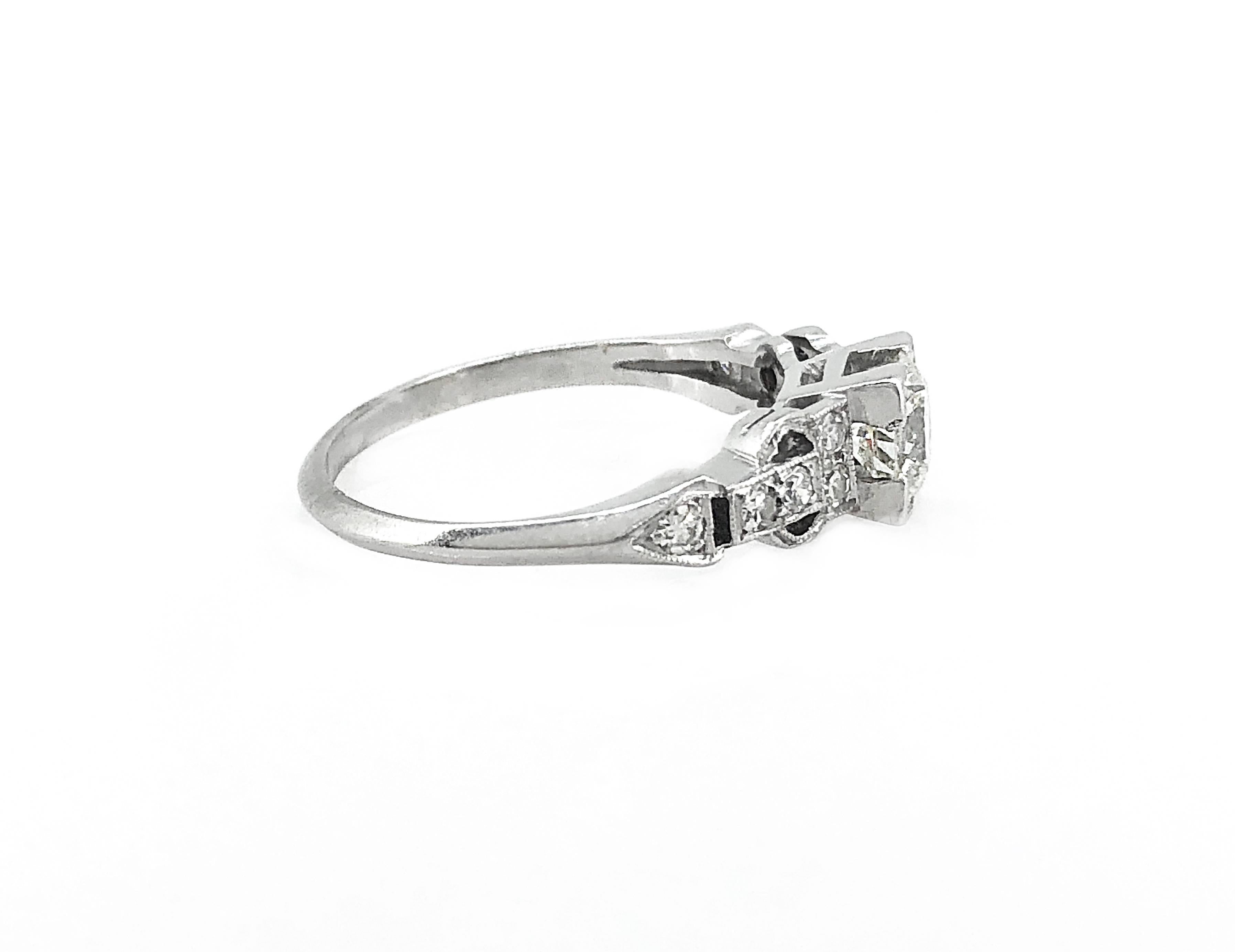 An elegant Art Deco platinum and diamond Antique engagement ring featuring a .60ct. apx. transitional cut diamond with VS1 clarity and J color. Additionally, the center diamond is accented with .20ct. apx. T.W. of single cut diamonds with VS1-VS2