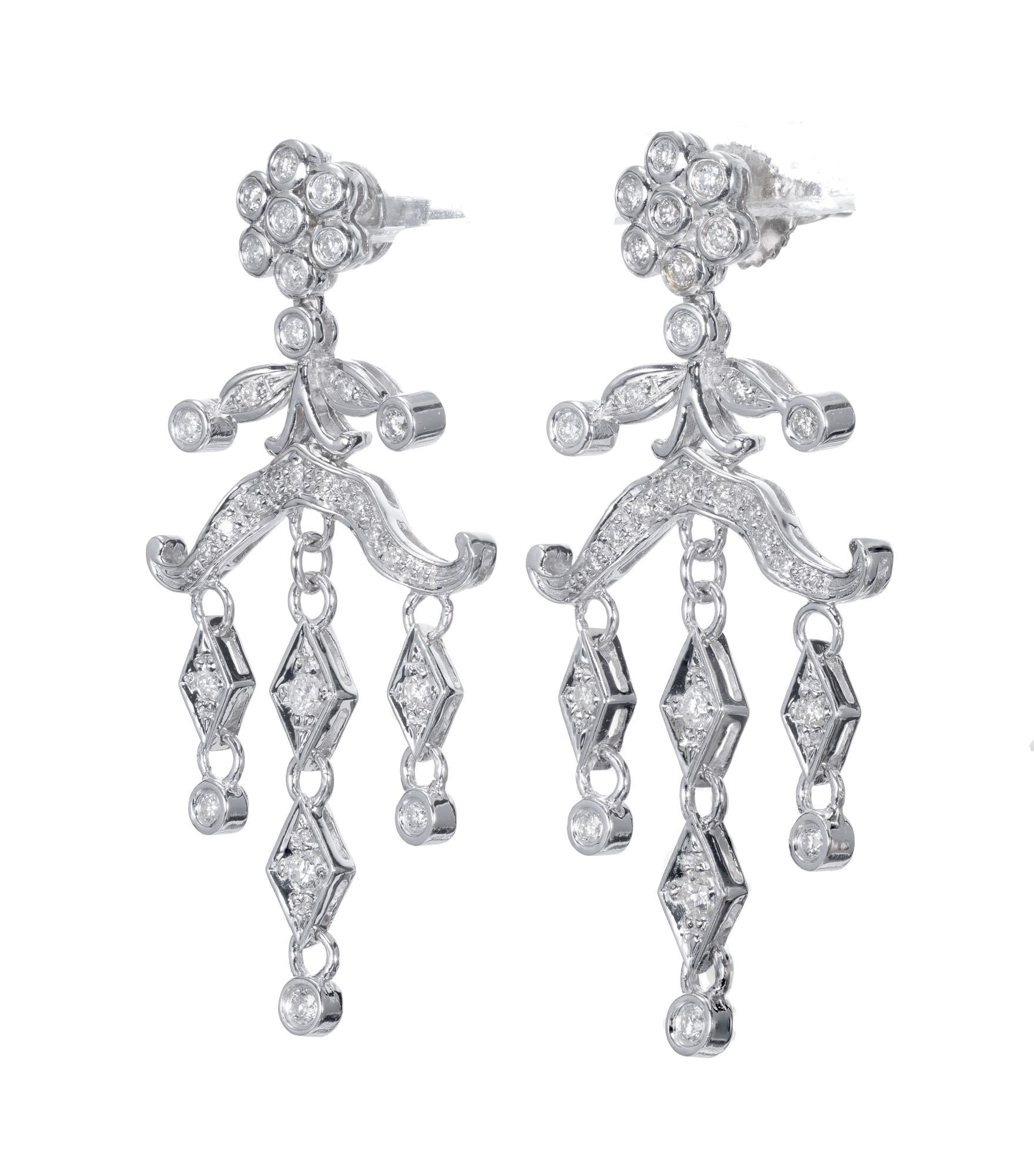 Chandelier style diamond dangle earrings. Set in 14k white gold with a cluster of diamonds at the top, two tiers and  of round accent diamonds.

56 Diamonds approx total weight .60cts
Length: 1.65 inches or 41.97mm
Width: .82 inches or