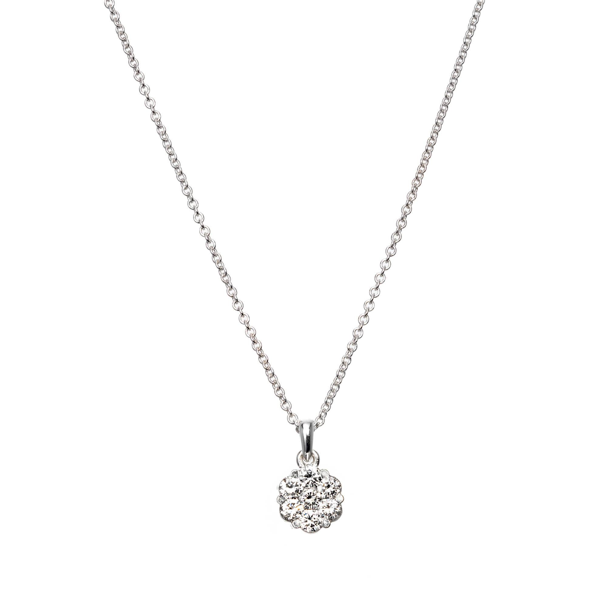 Diamond cluster pendant necklace, set in 18k white gold with .60 carats of round brilliant cut diamonds 

7 round brilliant cut G-H SI diamonds, Approx. .60 carats 
18k White Gold 
Stamped: 18k
3.4 Grams
Top to Bottom: 7.6mm or .30 Inches
Width: 7.8