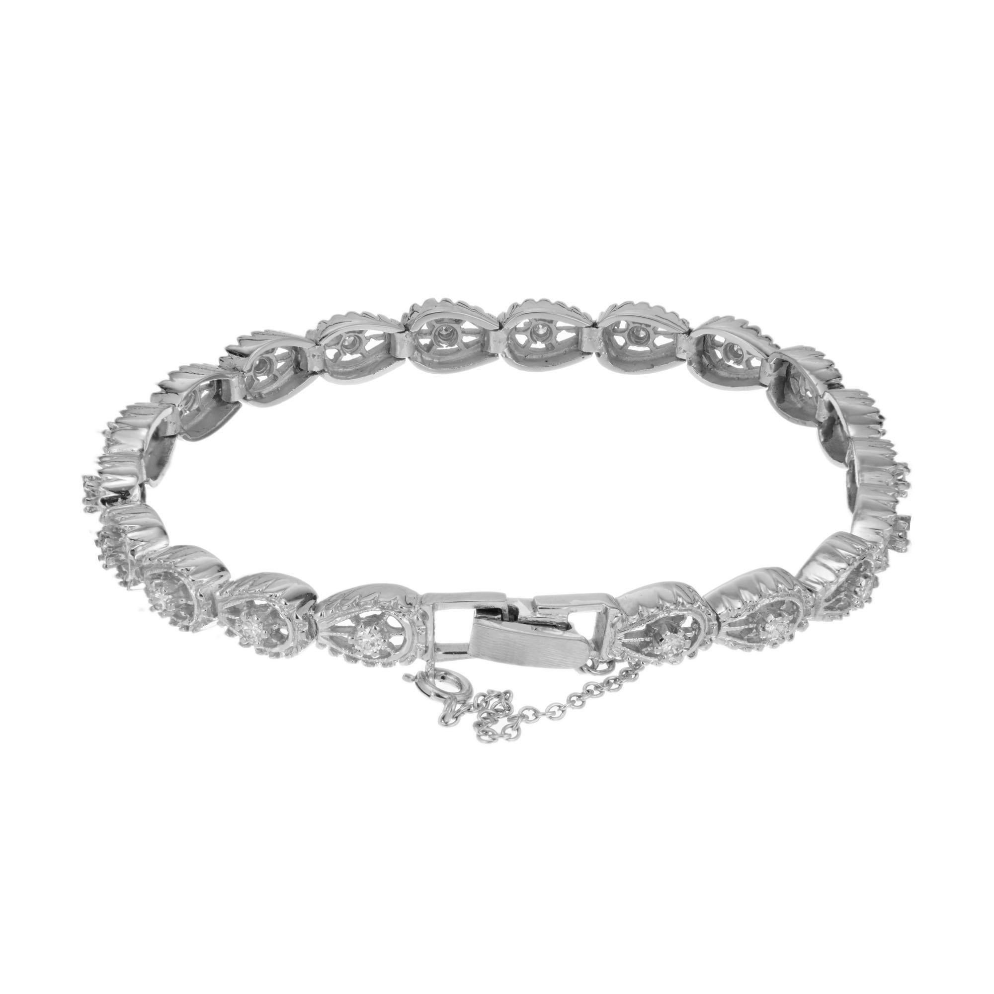 20 Horseshoe shaped links in 14k white gold each set with a bright white diamonds. Safety chain attached. 7 inches in length. 

20 round brilliant cut diamonds, G-H VS approx. .60cts
14k white gold 
Stamped: 14k
17.2 grams
Bracelet: 7 Inch
Width: