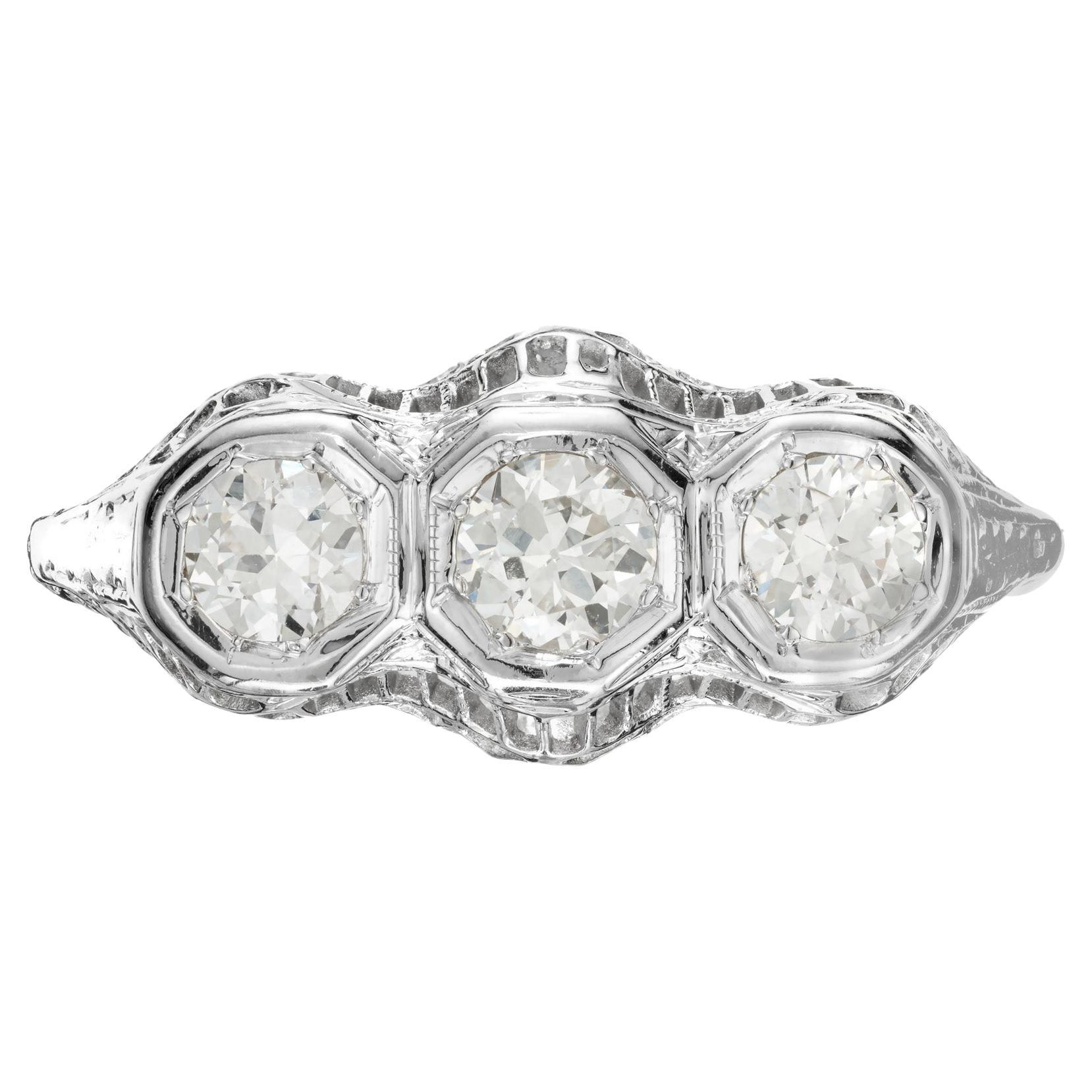 1930's round diamond, three-stone ring. .60cts of diamonds set in a filigree 18k white gold setting. 

3 round diamonds, G VS2 approx. .60cts
18k white gold 
Stamped: 18k
2.7 grams 
Width at top: 8.5mm
Height at top: 5.8mm
Width at bottom: 1.3mm
