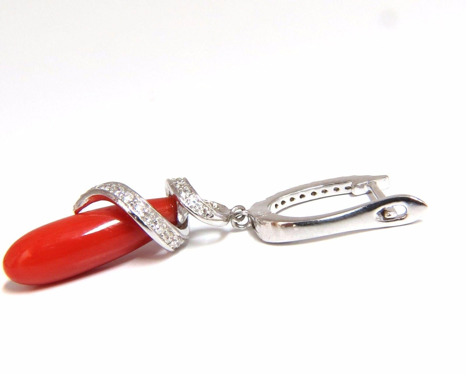 Classic Natural Coral Dangle Form Earrings.

Ox Blood Prime

17 X 5.5mm

Classic Red Luster

.60ct. Round Brilliant diamonds. 

 Full cuts.

G color Vs-2 clarity. 

Total Earring length: 1.5 inch long

 6 grams.

14kt. white gold.

$4000 appraisal