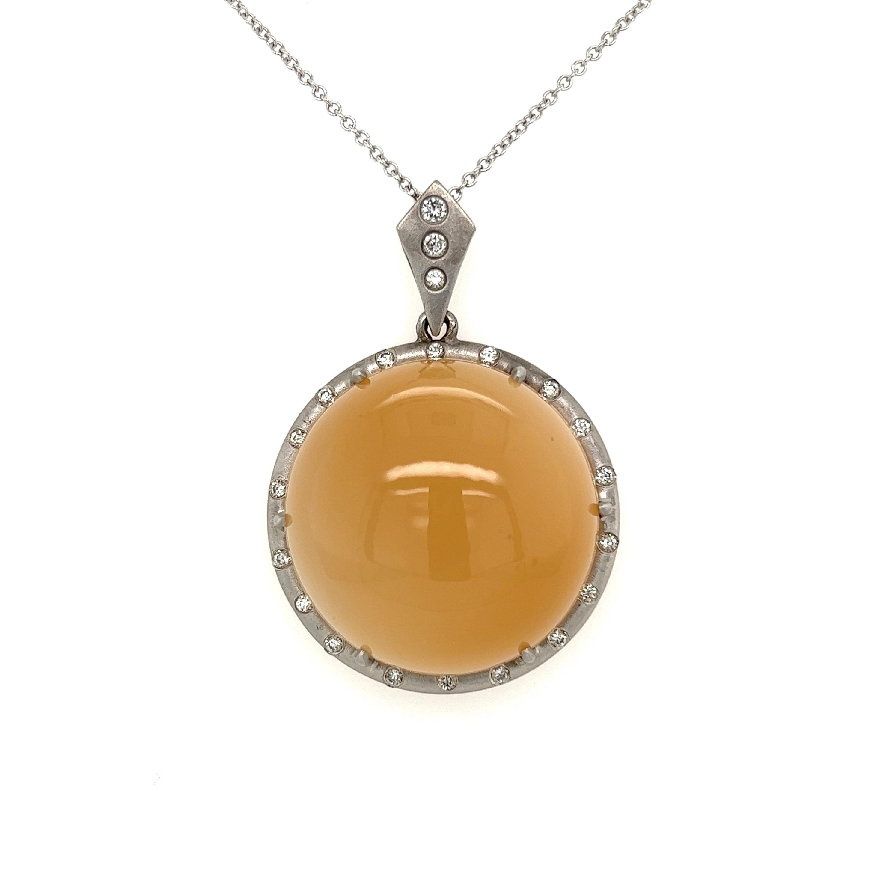 Simply Beautiful! Finely detailed Art Deco Revival Moonstone and Diamond Gold Pendant Necklace. Centering a securely nestled Hand set 60 Carat Round Cabochon Moonstone, surrounded by Scattered Diamonds, weighing approx. 0.45tcw. Hand crafted in 18K