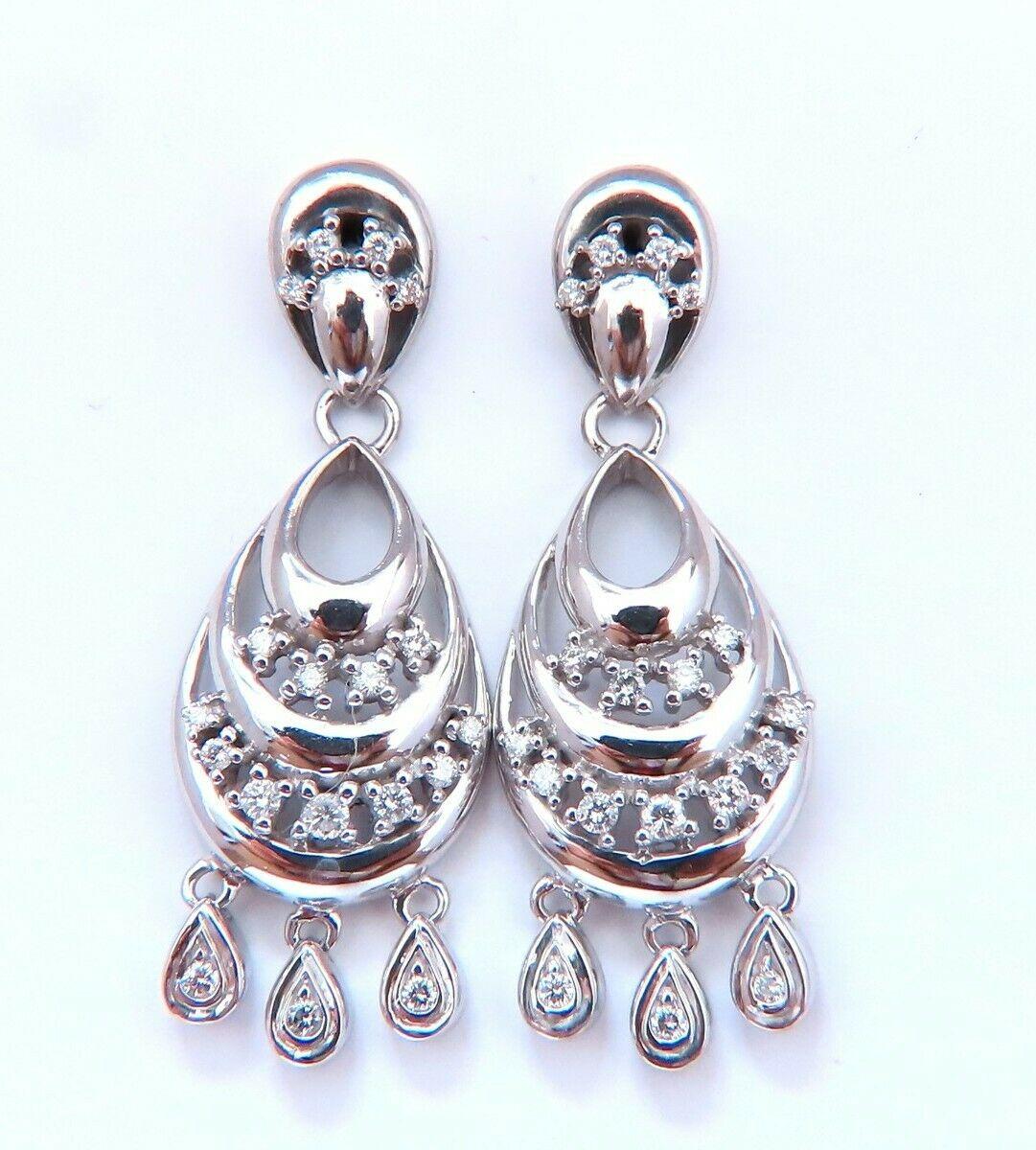 Semi crescent dangle loop earrings.

.60cts of natural round diamonds:

H-color, Vs-2 clarity.

14kt. white gold 10 grams.

Earrings measure: 1 inch long

.55 inch wide

Comfortable butterfly closure

$4000 Appraisal Certificate to accompany

Free