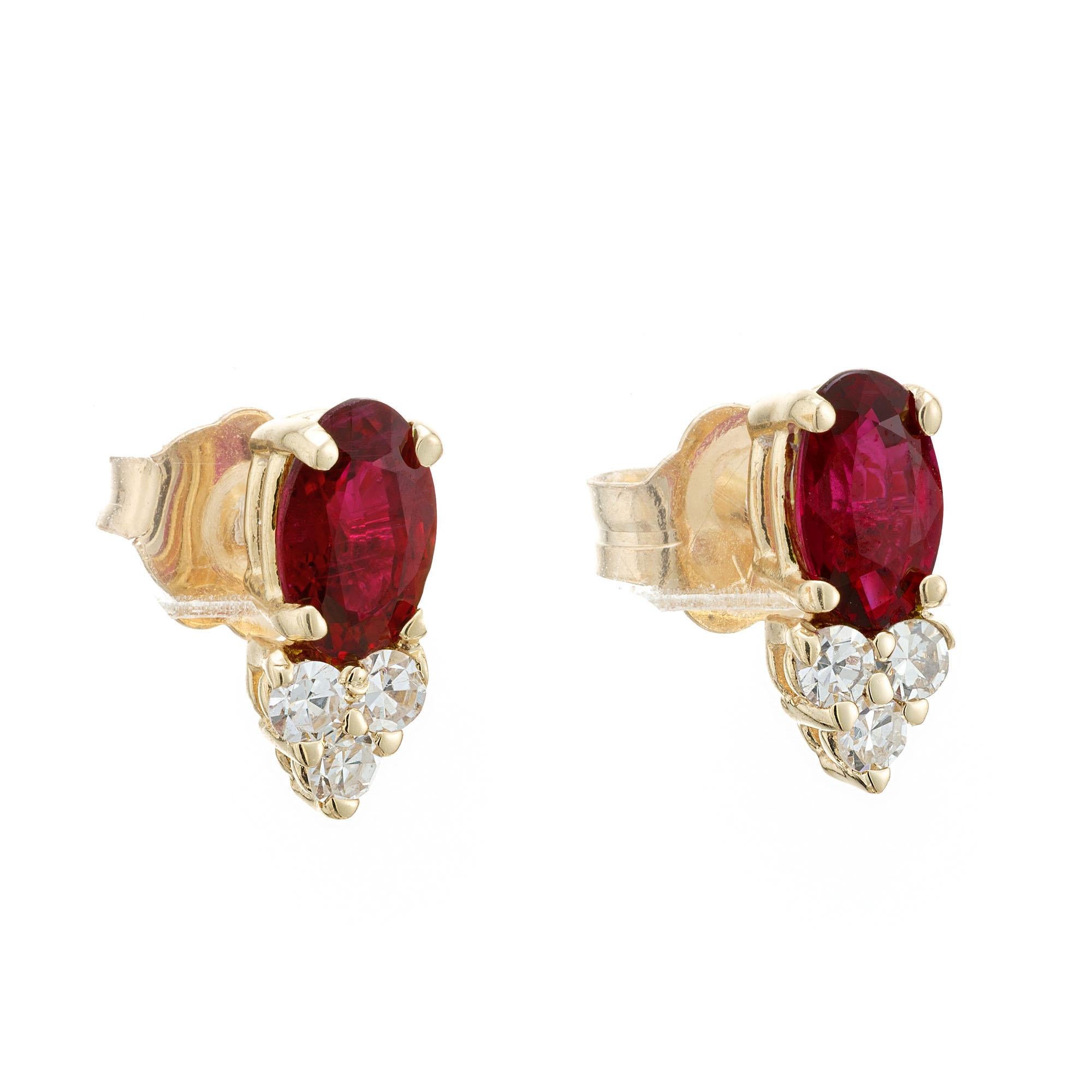 Ruby and diamond earrings. 2 oval rubies, each with 3 single cut accent diamonds set in 14k yellow gold.  

2 oval natural red rubies, SI approx. .60cts
6 single cut diamonds, H VS approx. .9cts
14k yellow gold 
Stamped: 14k
1.2 grams
Top to bottom: