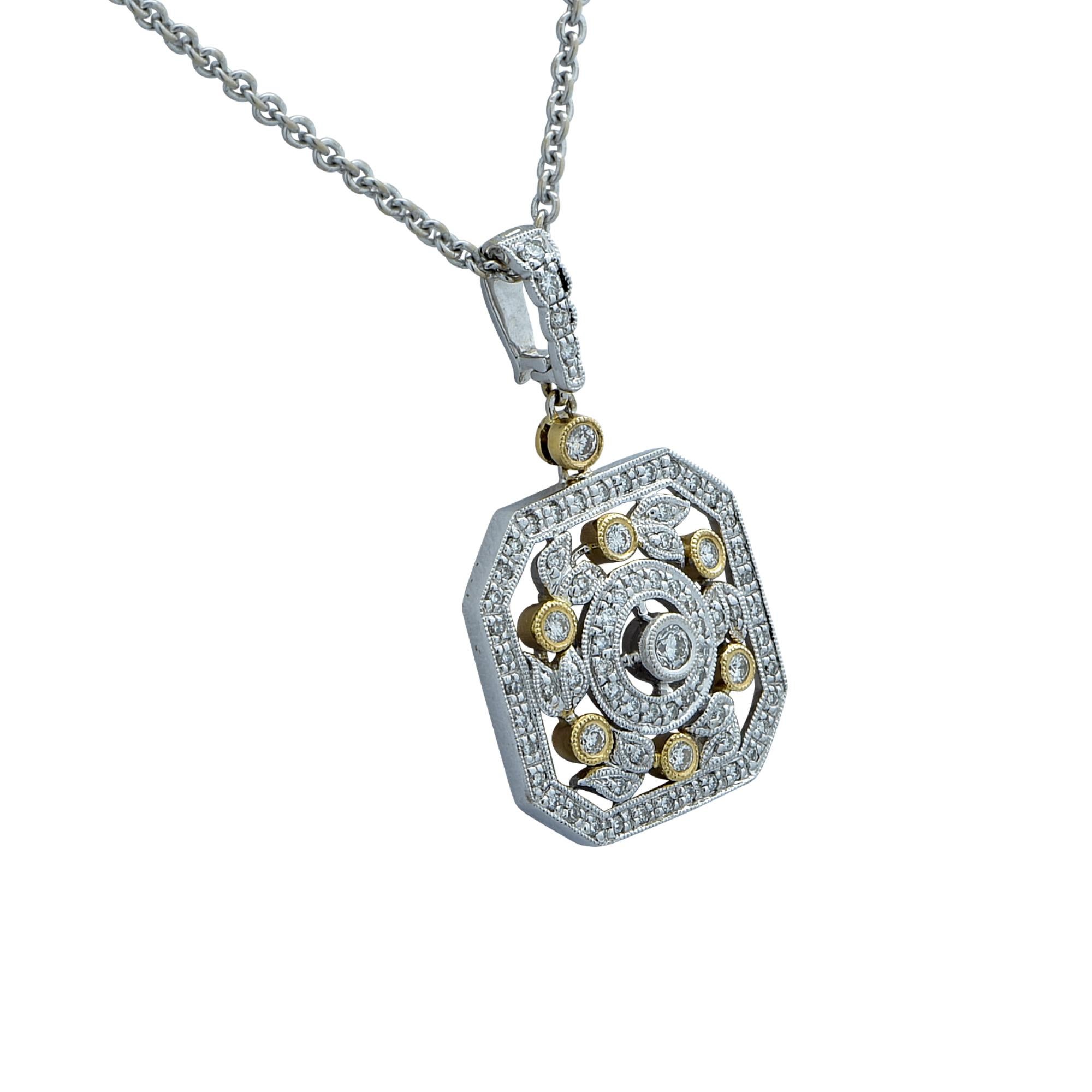 This fabulous necklace is crafted 14k white and yellow gold and studded with 52 round brilliant cut diamonds weighing approximately .60 carats total, G-H Color, SI Clarity.  The chain measures 16 inches in length and the pendant measures .8 inches