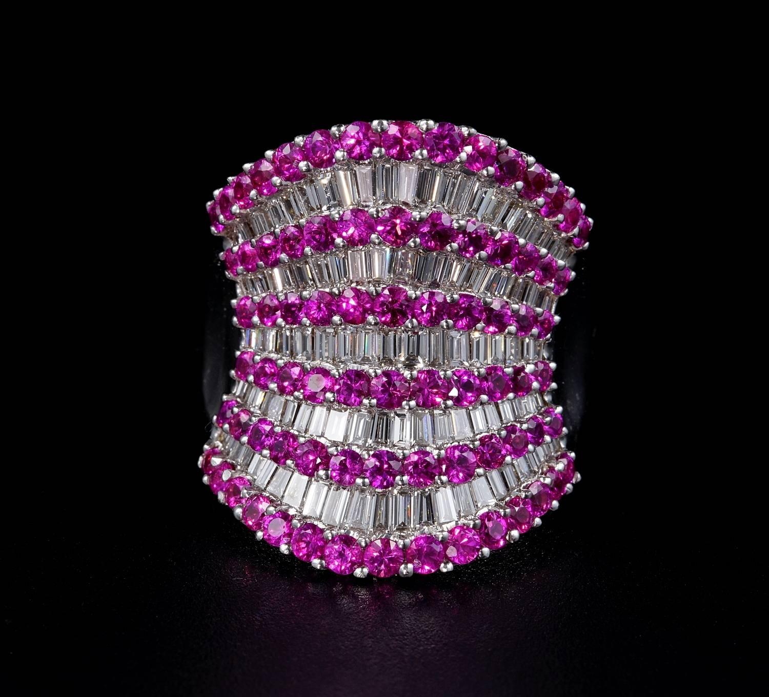 Quite outstanding and exclusive vintage ring, designed to impress like a wide band overwhelmed by Diamonds in finest hand set. Contrasted by Pink Sapphires for more effect.
The ring is of great value further than being an unique.
It boasts 6.0