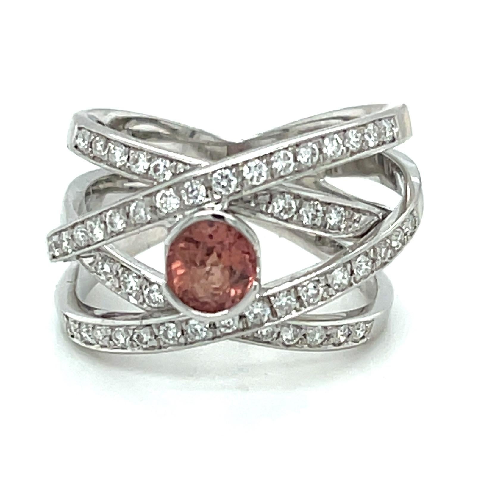 This gorgeous ring features a rare padparadscha sapphire that has been bezel-set in a beautiful 18k white gold band. Highly-prized by gem collectors and jewelers alike, padparadscha sapphires possess a unique blend of pinkish-orange or orangey-pink