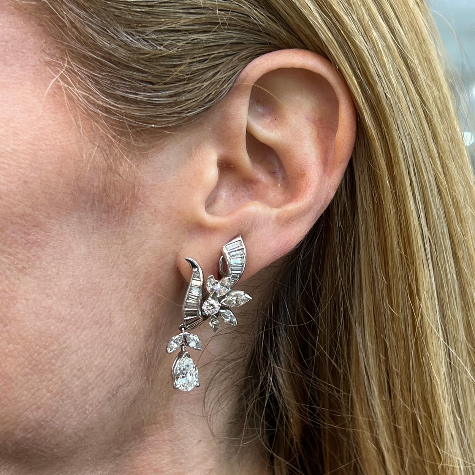 Stunning diamond drop earrings handcrafted in platinum. These Estate earrings feature 2 pear shape drop diamonds weighing 2.23 carat total weight. The round brilliant, baguette, and marquise shape diamonds weigh another 3.90 carats (6.13 CTW). The