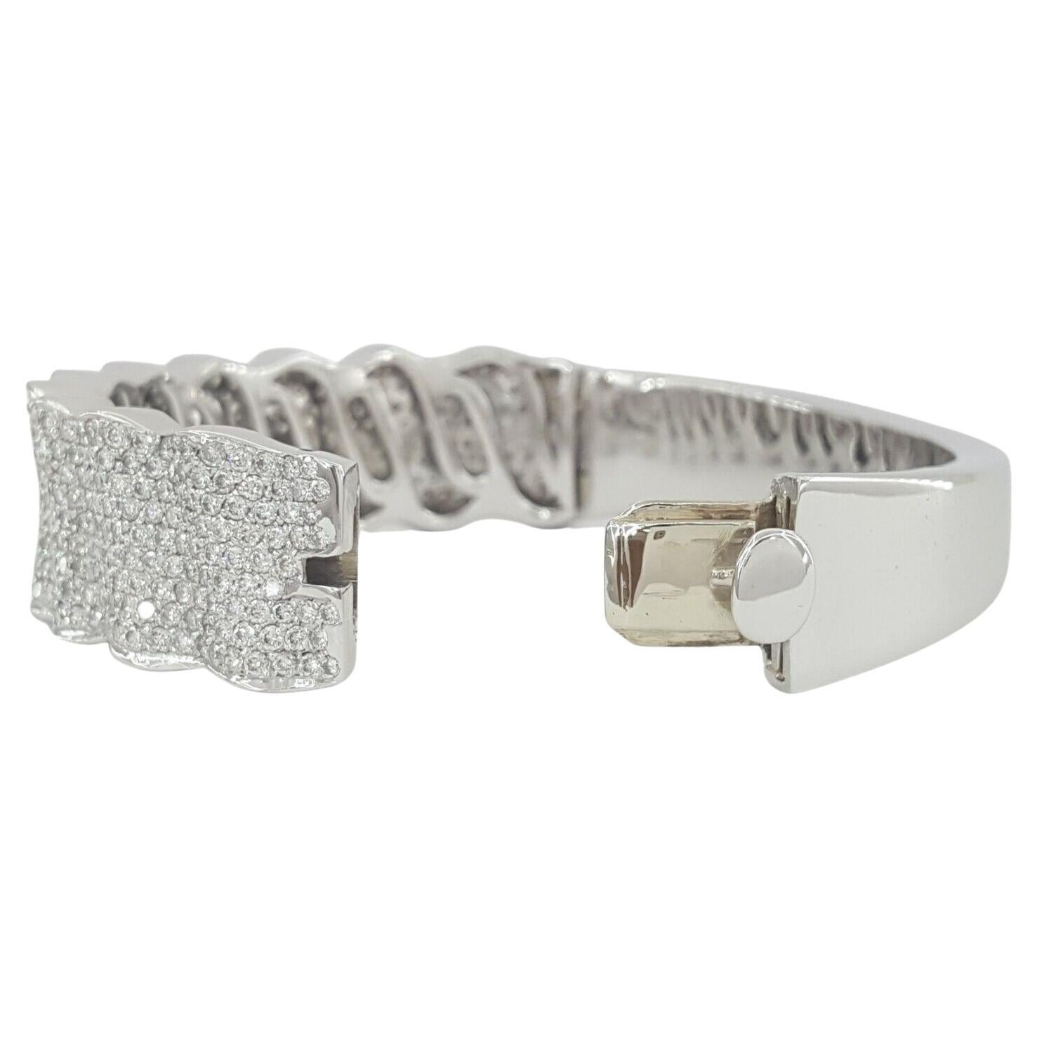 8K White Gold Round Brilliant Cut Diamonds Nine 9-Row Pave Wave Bangle / Bracelet. 

The bracelet weighs 59.2 grams, 6.5 inches long, contains 552 Natural Round Brilliant Cut Diamonds weighing approximately 10 ct, E-G in color, & VS1-SI1 in