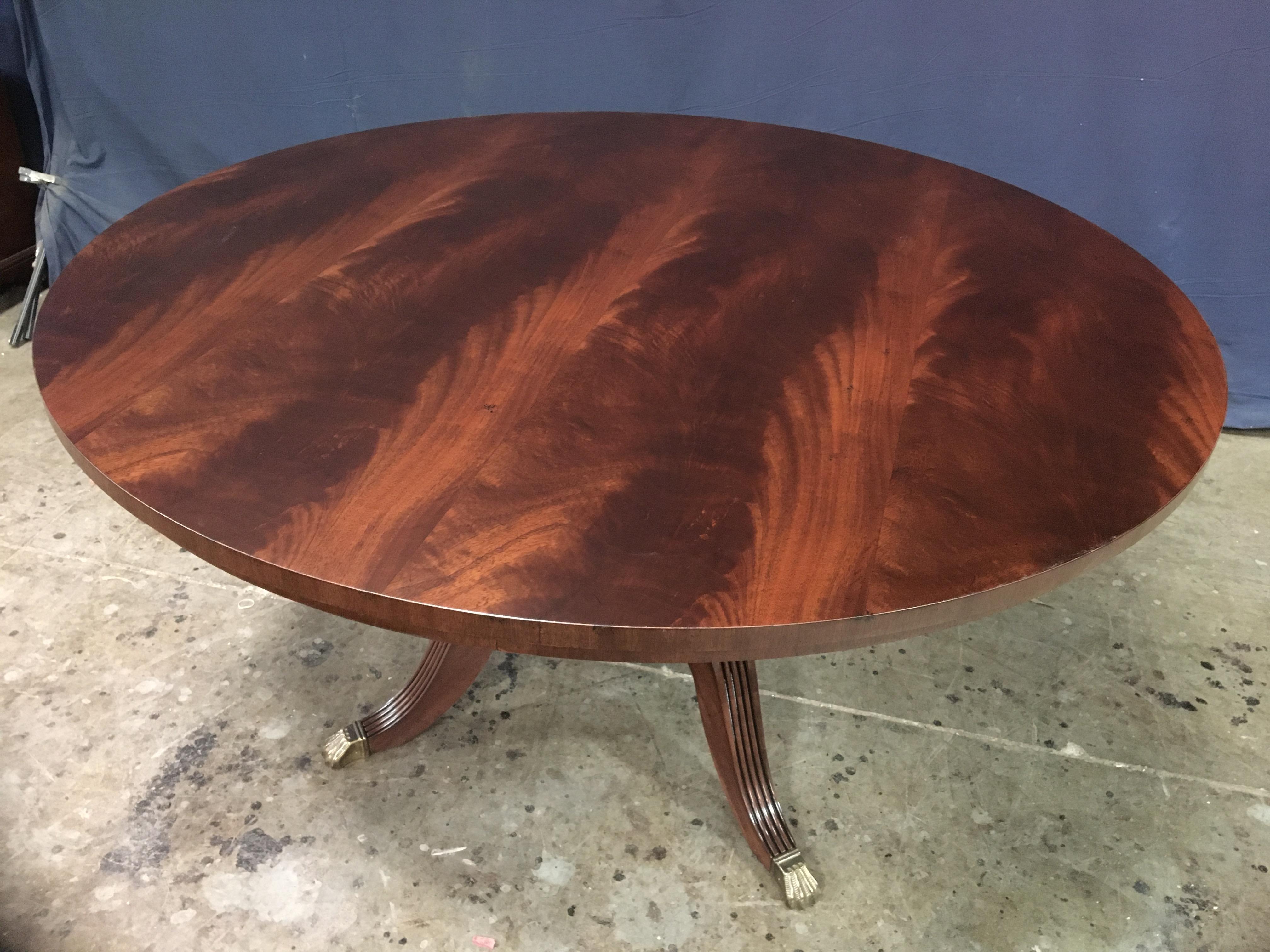 This is made-to-order round traditional mahogany dining table made in the Leighton Hall shop. It features field of slip-matched West African swirly crotch mahogany. The top has a satin finish with mild distressing which allows it to blend in with