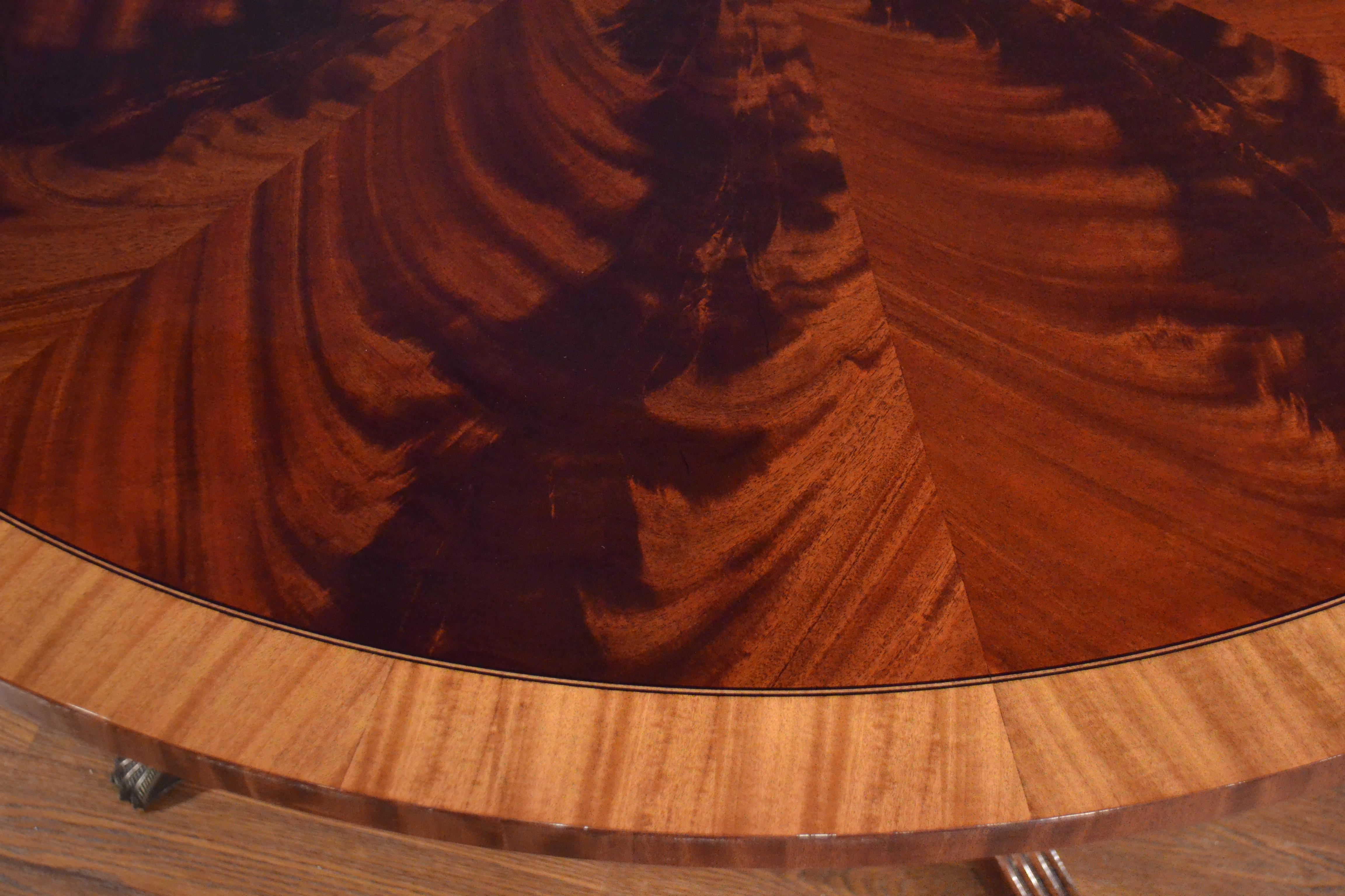 Cette table à manger ronde traditionnelle en acajou est fabriquée sur commande dans l'atelier de Leighton Hall. Il présente un champ d'acajou d'Afrique de l'Ouest à coupe radiale et une bordure de bois de satin. Une incrustation d'ébène et d'érable