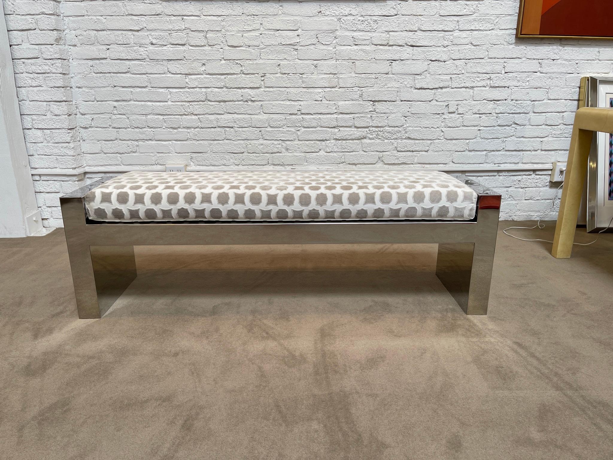 Polished steel upholstered 60 in bench from luxury furniture line. Beautiful condition. Extremely well made. Sturdy, heavy and ready for use. A good look for the foot of the bed or a variety of other places.