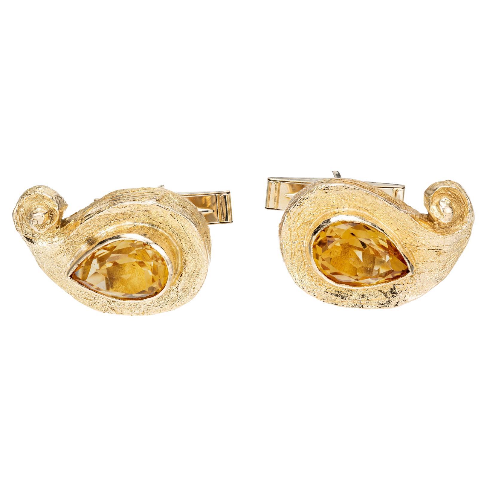 1960's Citrine men's cufflinks. 2 pear shaped citrines totaling 6.00cts. Set in 18k textured yellow gold. 

2 Pear shaped citrine. 6.00cts  12.1x8.8 mm
Top to bottom: 23.7mm or .93 inches
Width: 15.8mm or .62 inches
Depth or thickness: 7.0mm
Weight: