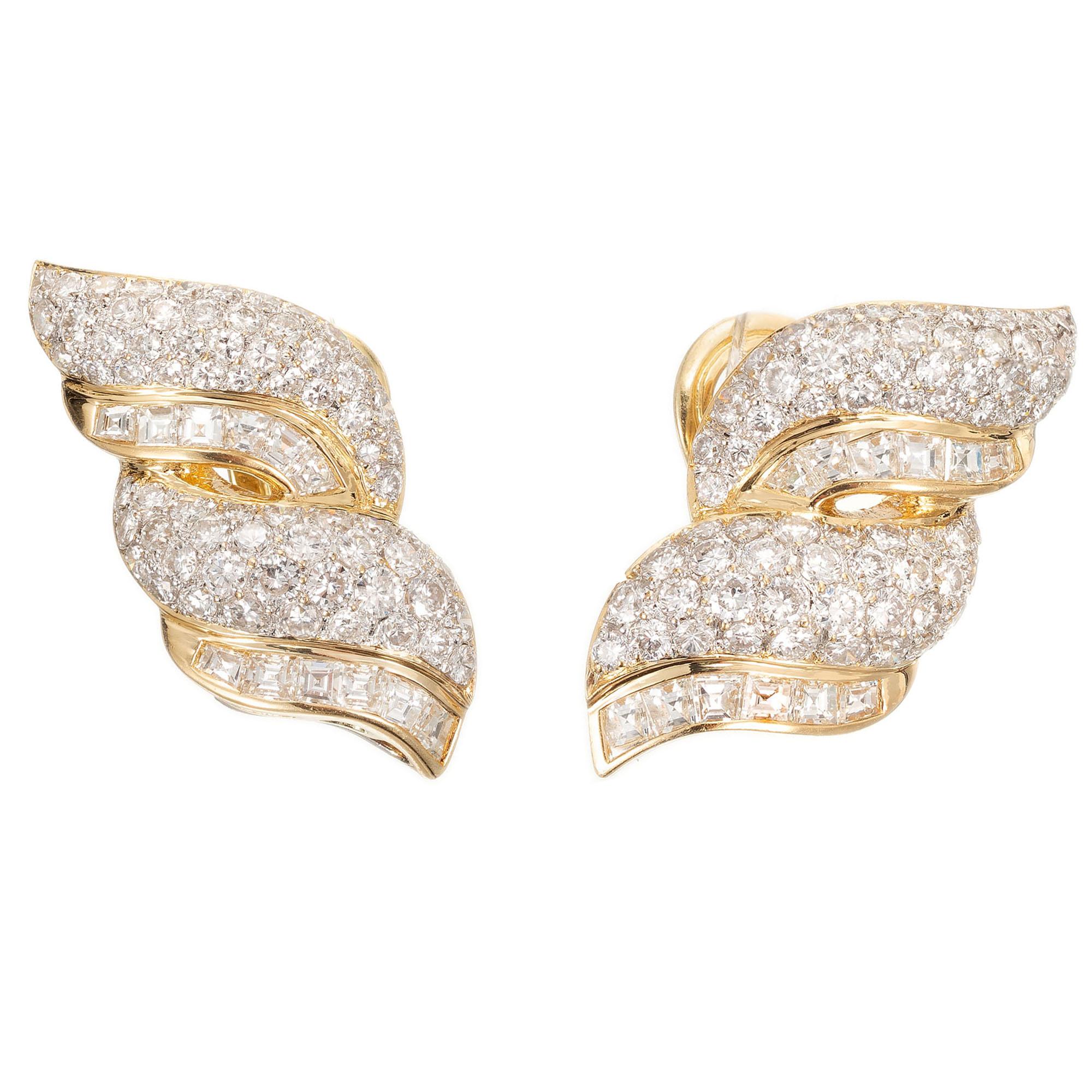 Swirl design diamond earrings. set with 138 round brilliant cut diamonds and 24 square step cut diamonds in a 18 karat gold clip post earrings with a wire loop at the bottom to hold a dangle.

138 round brilliant cut diamonds, G VS approx. 4.30cts
