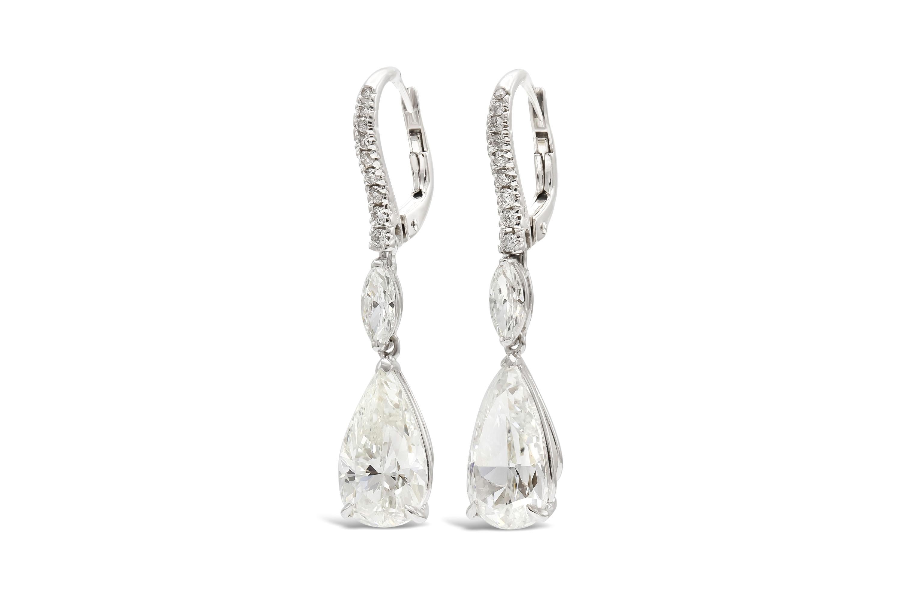 Finely crafted in 18k white gold with two GIA certified Pear Shaped diamonds.
One weights 3.00 carats, H color, SI2 clarity
GIA#2225366408
The other also weighs 3.00 carats, I color, SI1 clarity
GIA#6224366414
The earrings feature Marquise and Round