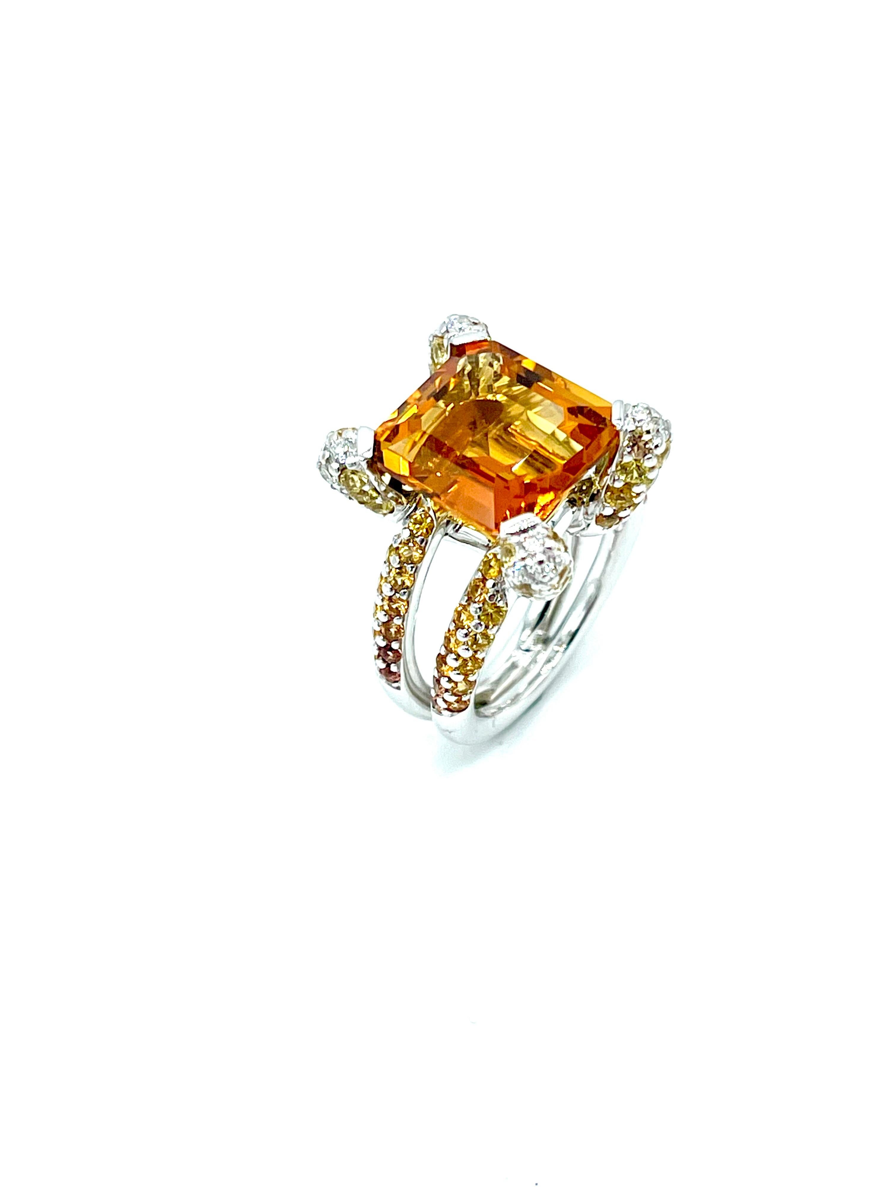 A truly stunning work of art!  This Madeira Citrine fires up with light.  It is emerald cut and weighs 6.00 carats, set with four Diamond and Citrine pave prongs, with a pave Citrine split shank in 18K white gold.  There are 0.26 carats in round