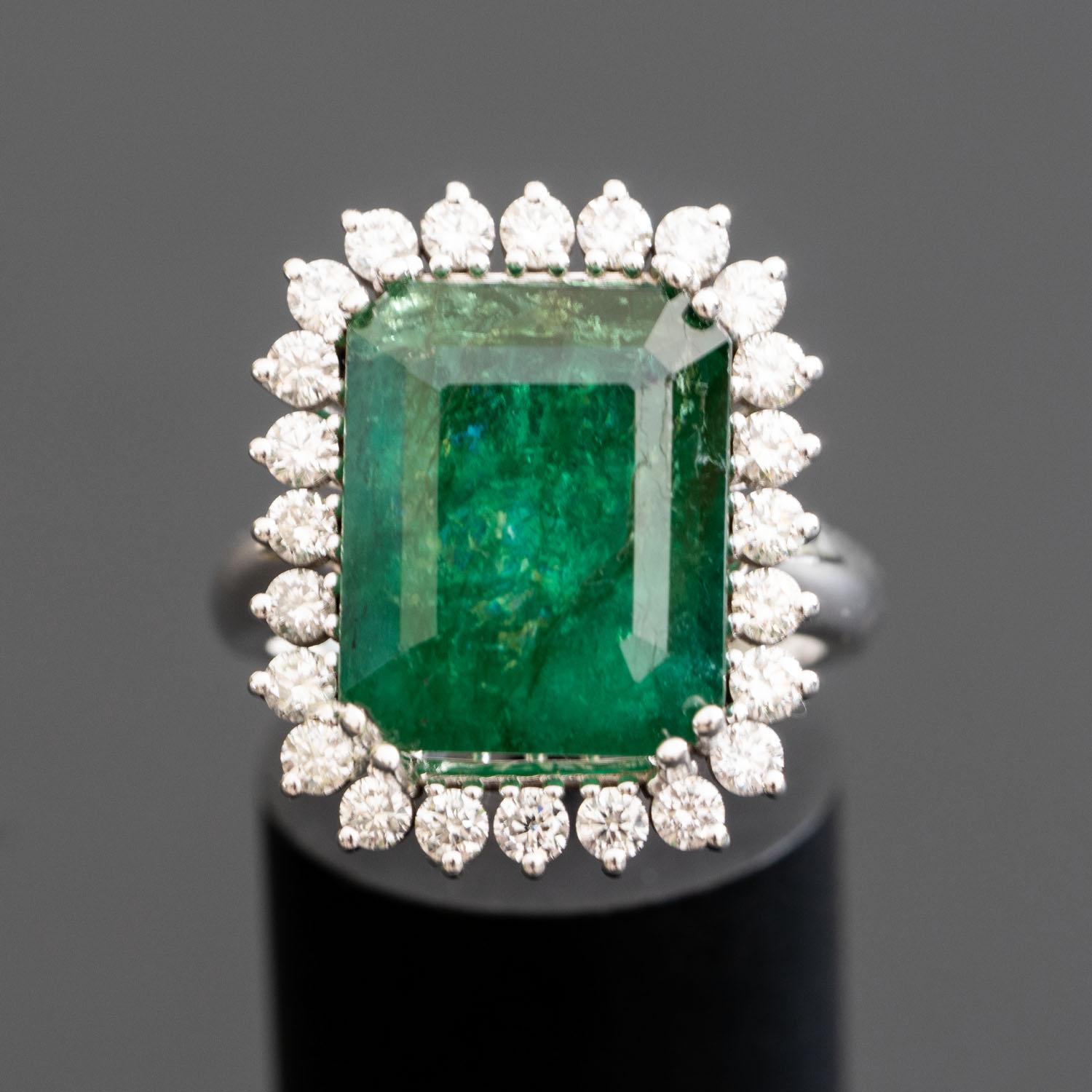 This large natural emerald diamond ring brings a lush touch of color to your fine jewelry collection. The generously-sized 13mm X 11mm central gemstone features the compelling green tones of natural emerald. The center gemstone is surrounded by 1.24