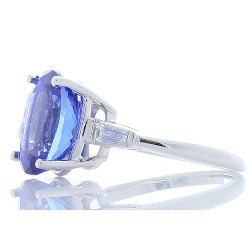 Leave a lasting impression when you pair this majestic tanzanite and diamond ring with your favorite ensembles. At the heart of this piece sits an absolutely stunning 6.0 carat oval tanzanite. The gem is sourced from Tanzania, near the foothills of