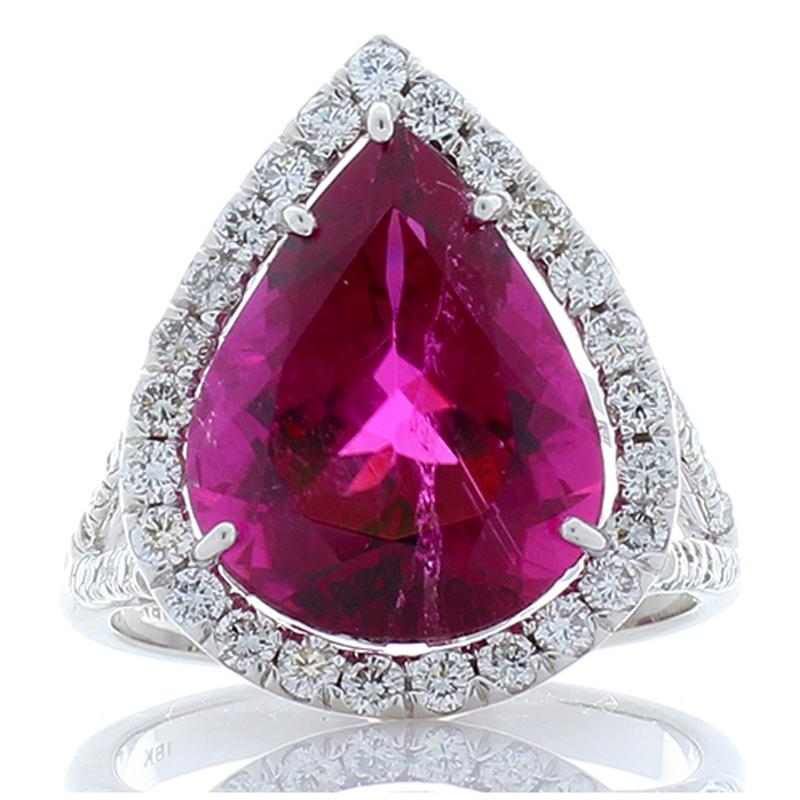 This magnificent raspberry-hued rubellite and diamond ring is an absolute showcase piece! Everything about this piece exudes luxury, starting with the illuminating pear cut 6.0 carat – 14.48 x 10.90 millimeter vivid rubellite. The stone is sourced