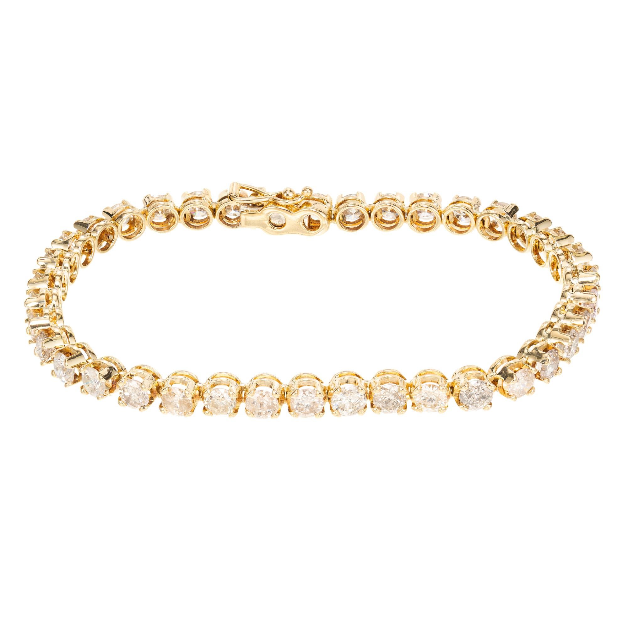 Diamond yellow gold tennis bracelet. This dazzling bracelets boats of 38 round cut diamonds with an approximate total carat weight of 6.00. and are meticulously set in radiant in 14k yellow gold. This bracelet measures 7 inches in length. It secured