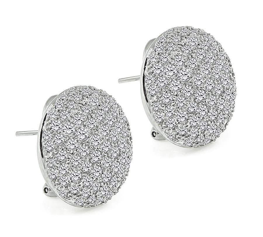 This is an elegant pair of 18k white gold earrings. The earrings feature sparkling round cut diamonds that weigh approximately 6.00ct. The color of these diamonds is G-H with VS clarity. The earrings measure 20mm in diameter and weigh 14.7 grams.