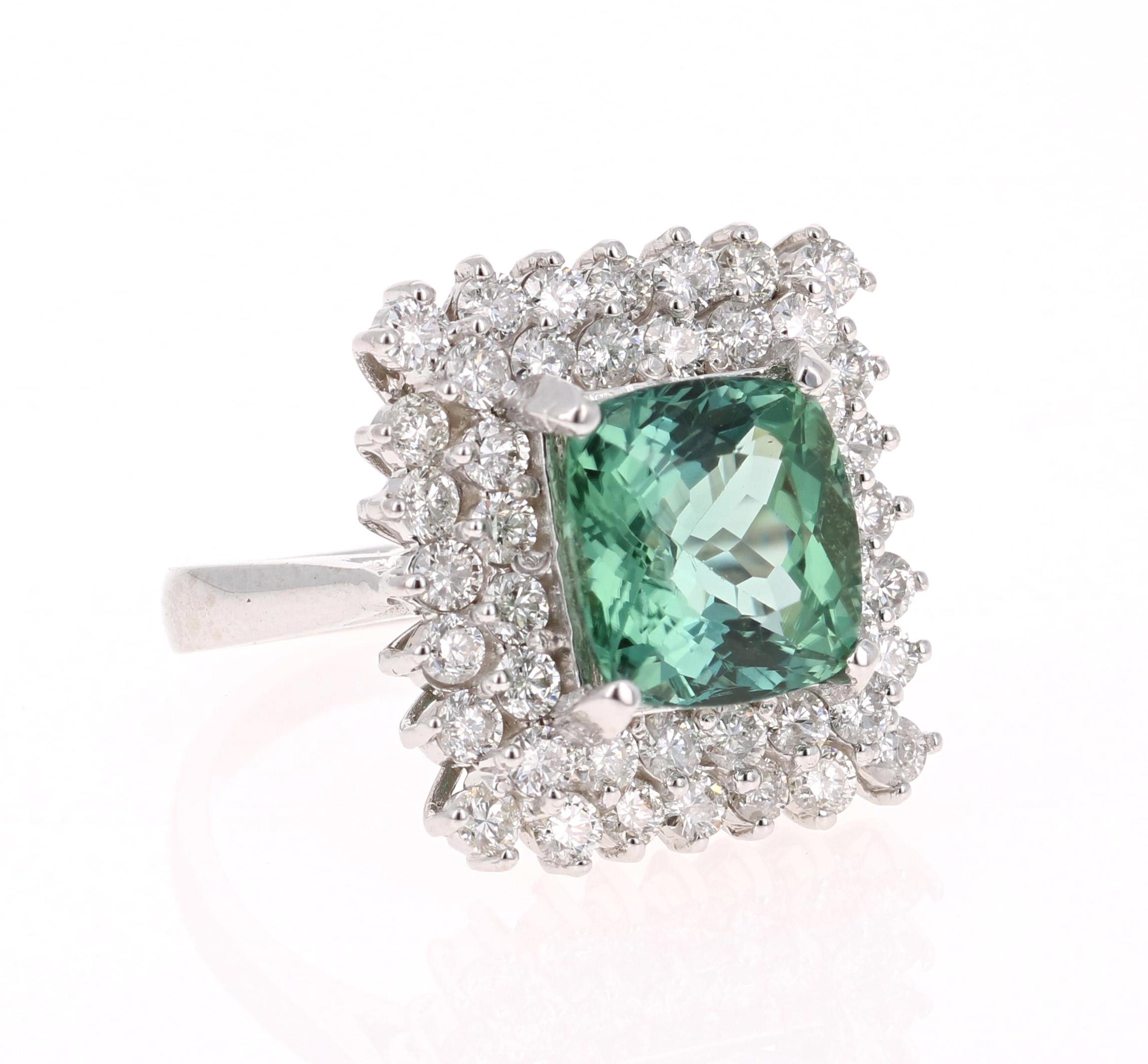 Gorgeous & Unique Cocktail Ring!

This ring has a STUNNING Cushion Cut Mint Green Tourmaline that weighs 4.30 Carats. Floating around the tourmaline are 44 Round Cut Diamonds that weigh 1.71 Carats. The total carat weight of the ring is 6.01 Carats.