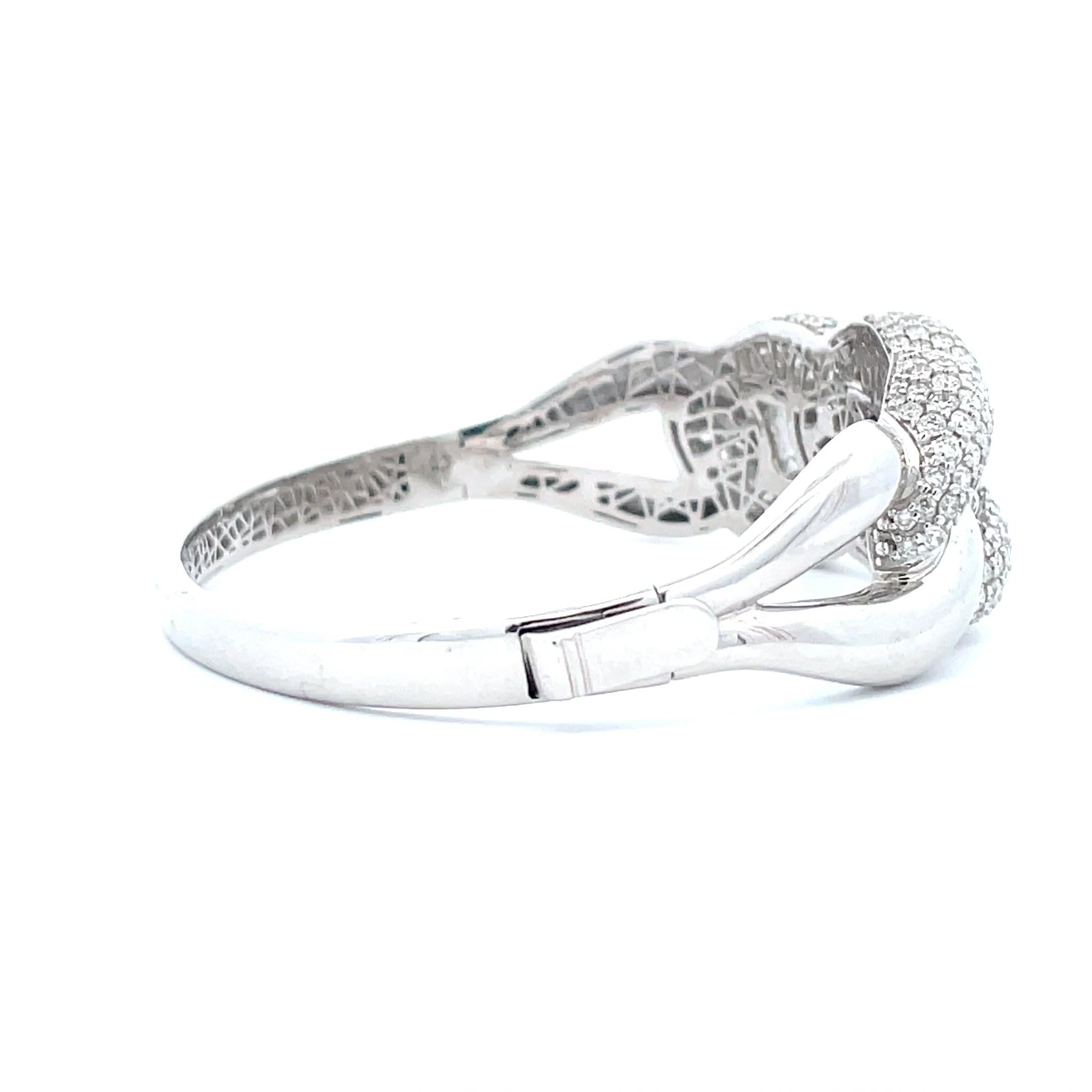 This 6.01 ct. Diamond Cluster Knot Link Bangle exemplifies the rare beauty of the diamond and showcases it to its best advantage. This beautiful piece is highly polished to enhance the reflective quality of its pave diamonds and is crafted by a