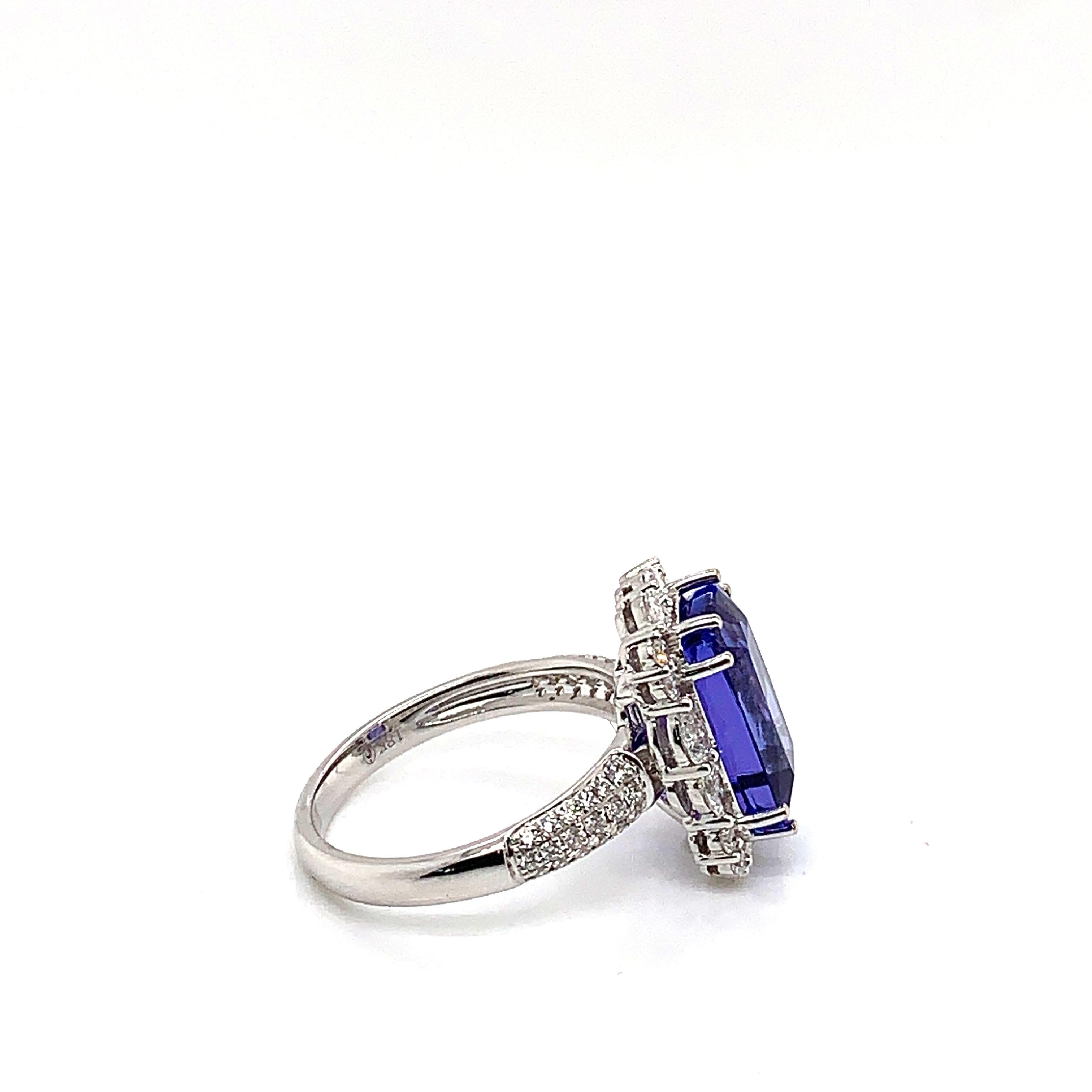 Classic tanzanite ring in 18K white gold with diamonds. 

Tanzanite: 6.014 carat cushion shape.
Diamonds: 0.774 carat, G colour, VS clarity. 
Gold: 4.515g, 18K white gold. 