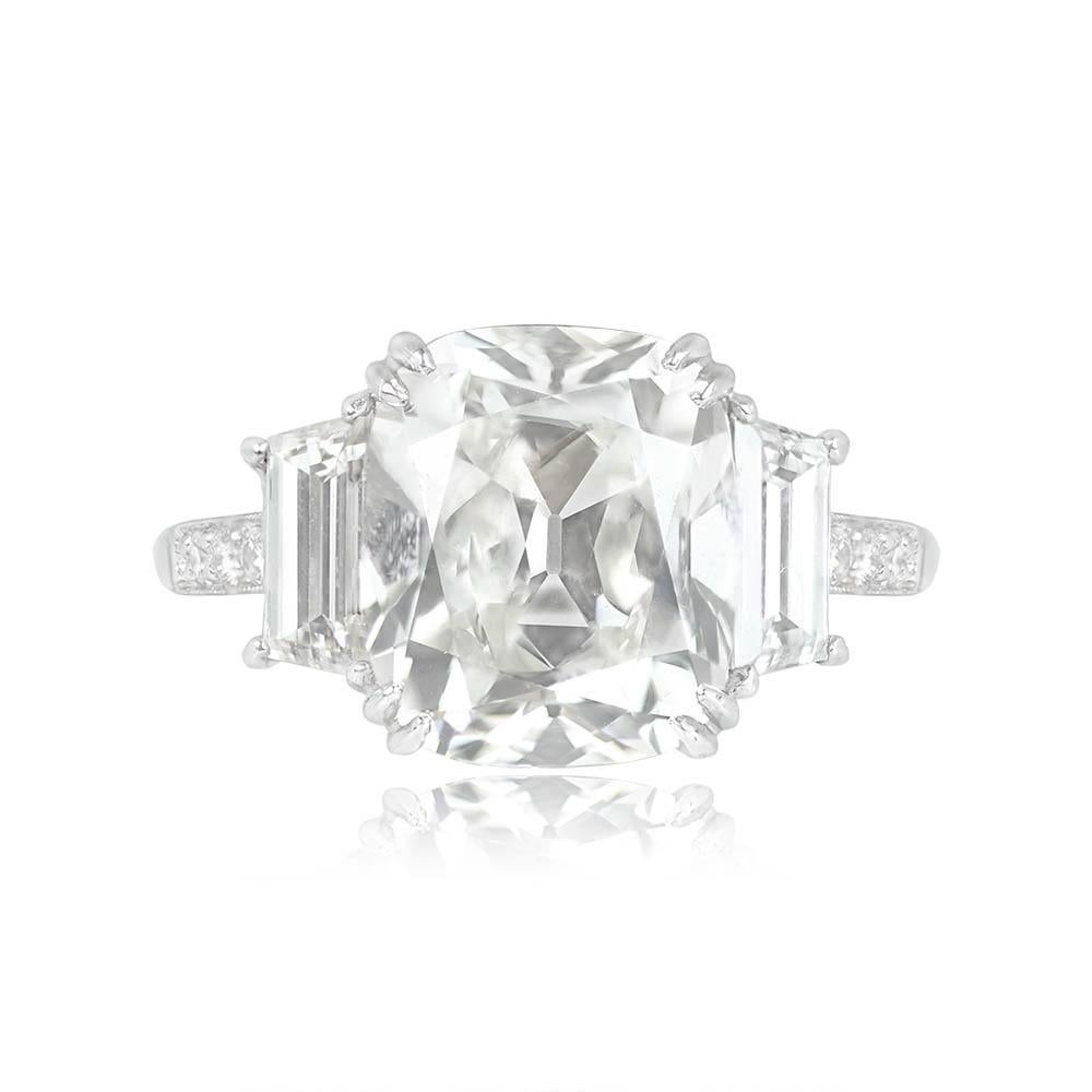 Three-stone engagement ring showcasing an antique cushion-cut diamond of 6.01 carats (I color, VS2 clarity), complemented by two baguette-cut diamonds weighing about 0.65 carats each. All three stones are prong-set in a platinum mounting.