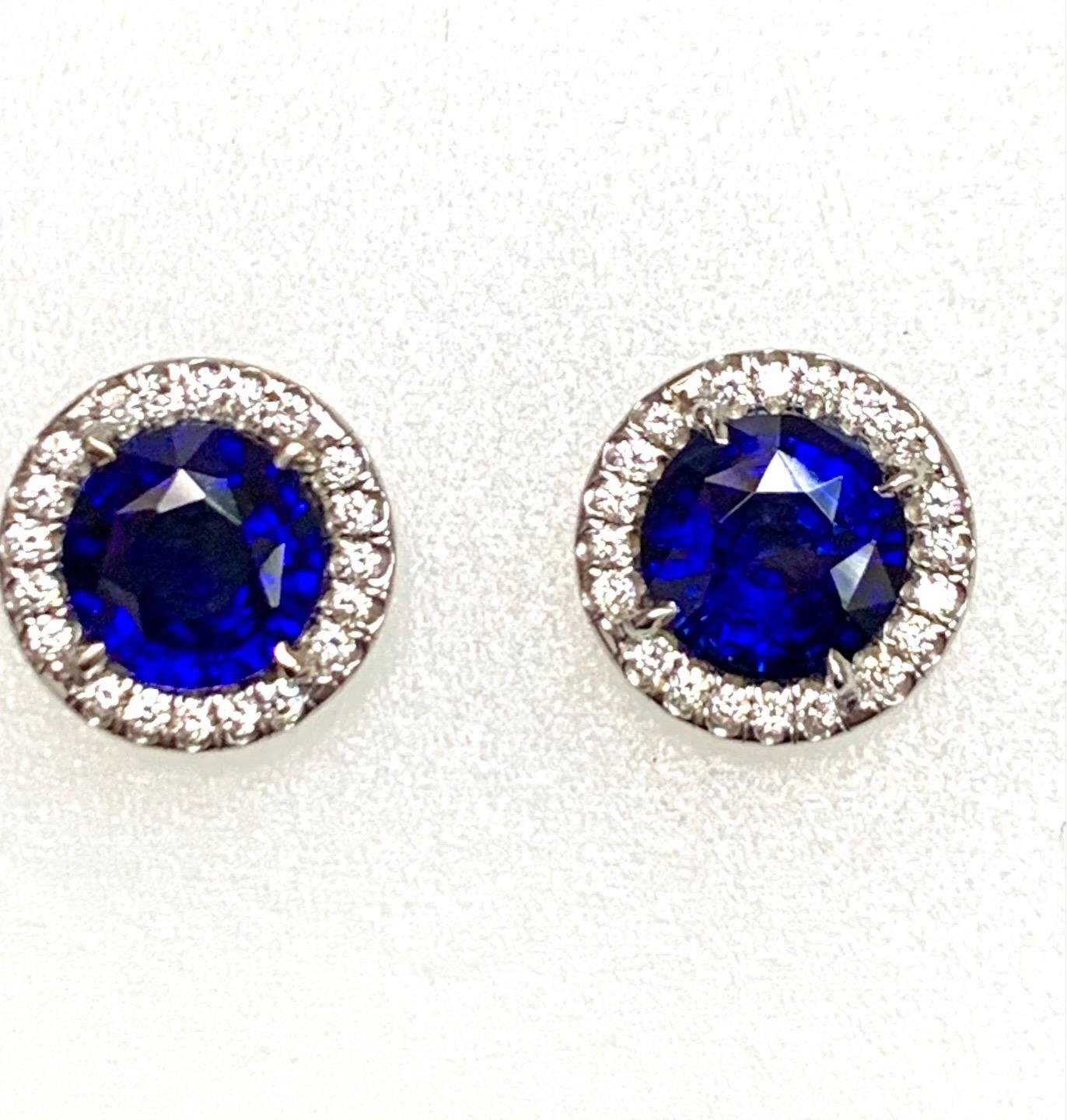 6.02 Carat round sapphire set in 18k white gold earrings with 0.60 carat pave set diamonds .