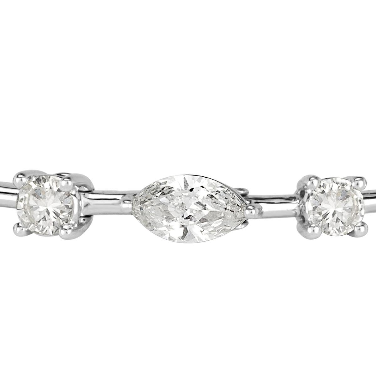This stunning diamond bracelet showcases 6.02ct of oval, marquise and round brilliant cut diamonds graded at F-G in color, VS1-VS2 in clarity. Each of the diamonds average 0.25ct. They are set in a custom, 18k white gold setting.
