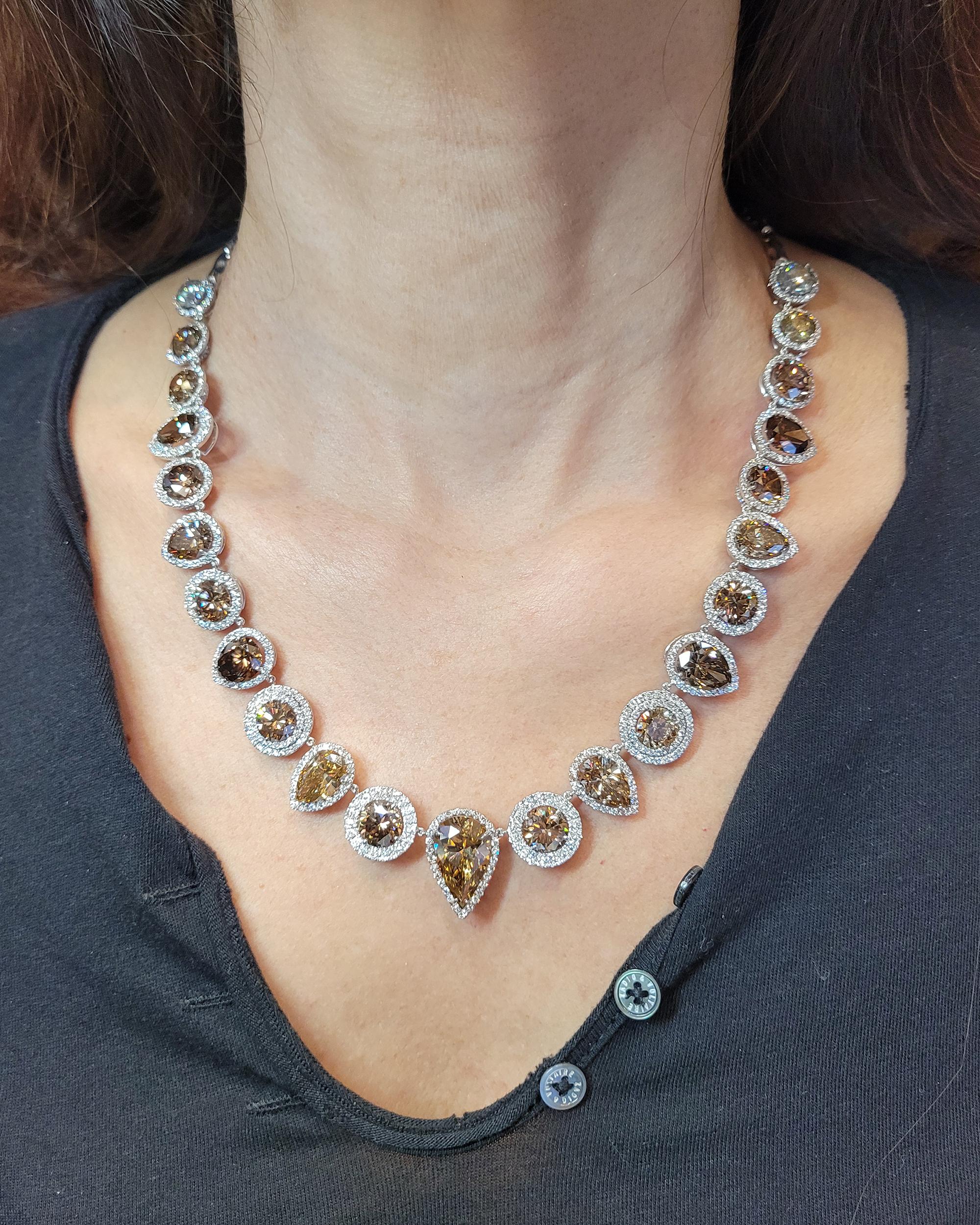 A beautiful necklace comprising of round and pear-shape diamonds of fancy brown, yellow and orangey-yellow colors. 23 diamonds weighing a total of 60.27 carats. 
The diamonds were certified by GIA but the original certificates are not